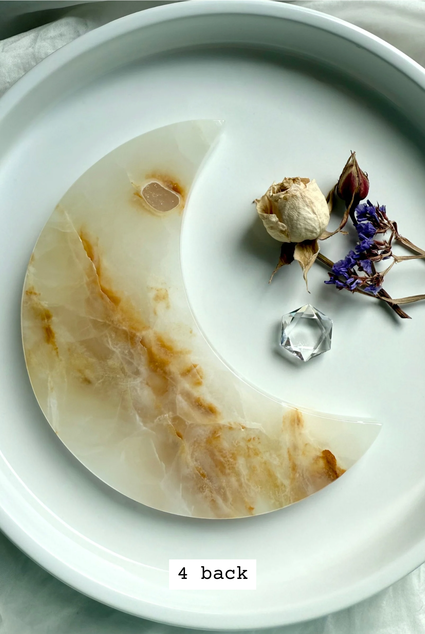 White Onyx Crescent Moon Plate, soft creamy ivory with warm golden hues, back view.