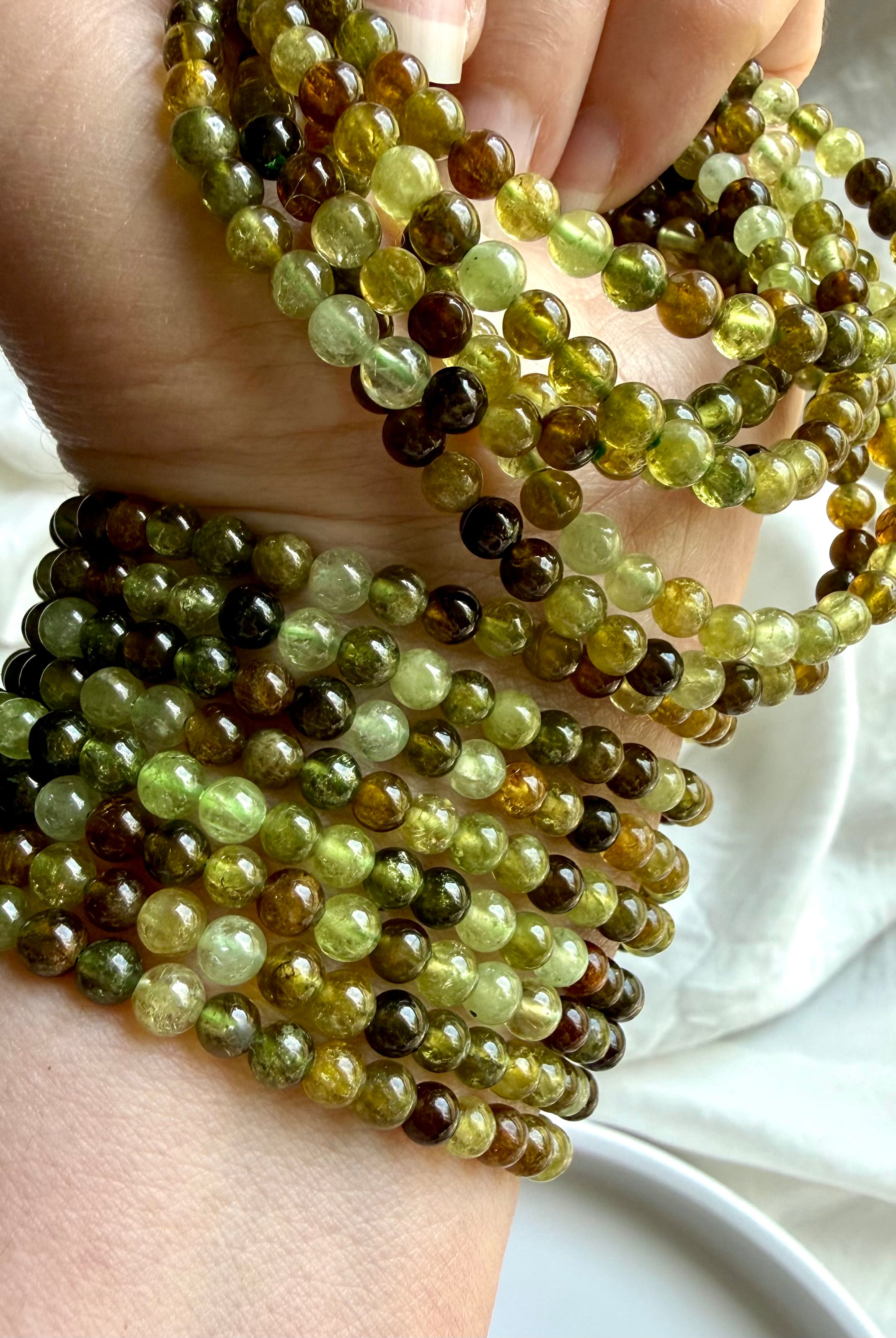 Tsavorite Garnet bracelets with luminous green gemstone beads in olive, chartreuse, amber, and deep forest tones