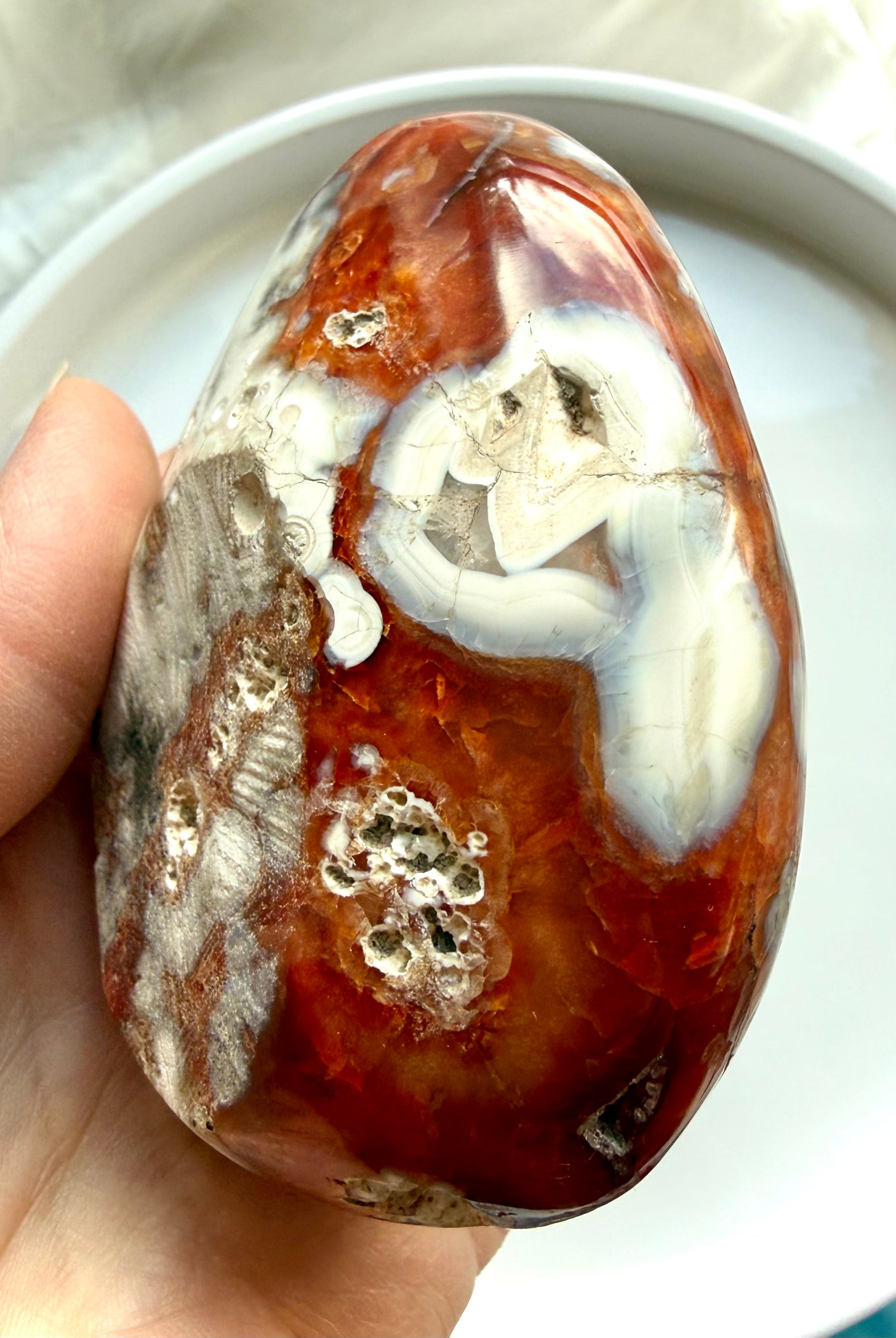 close up of carnelian bowl with orca agate inclusions and natural mineral texture