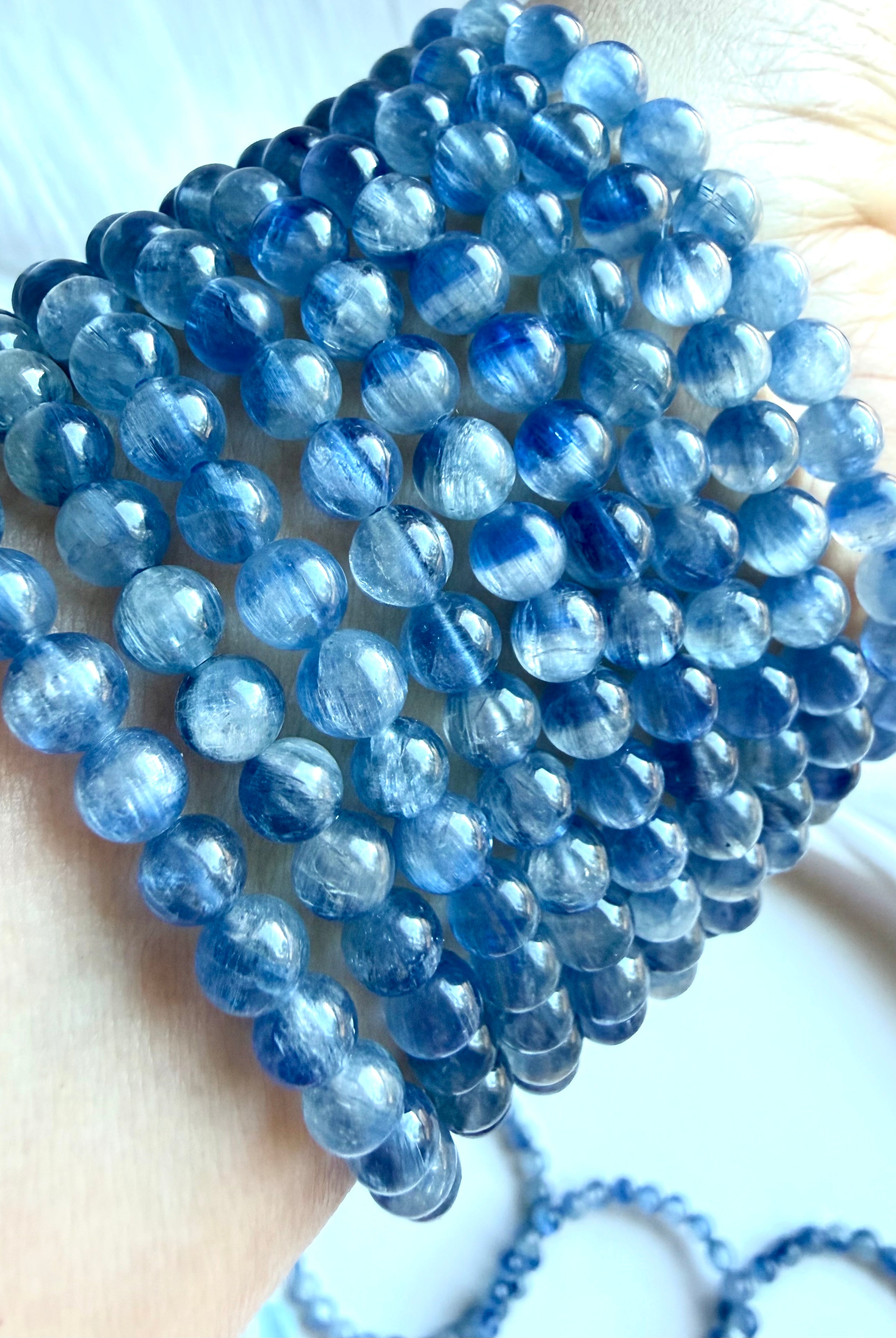 Blue Kyanite bracelet close-up showing two-tone blue gemstones with soft watercolor-like variation