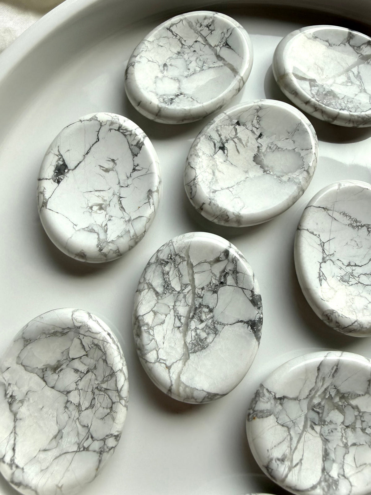 Natural Howlite worry stones with white and gray veining, polished oval shape and calming tactile design