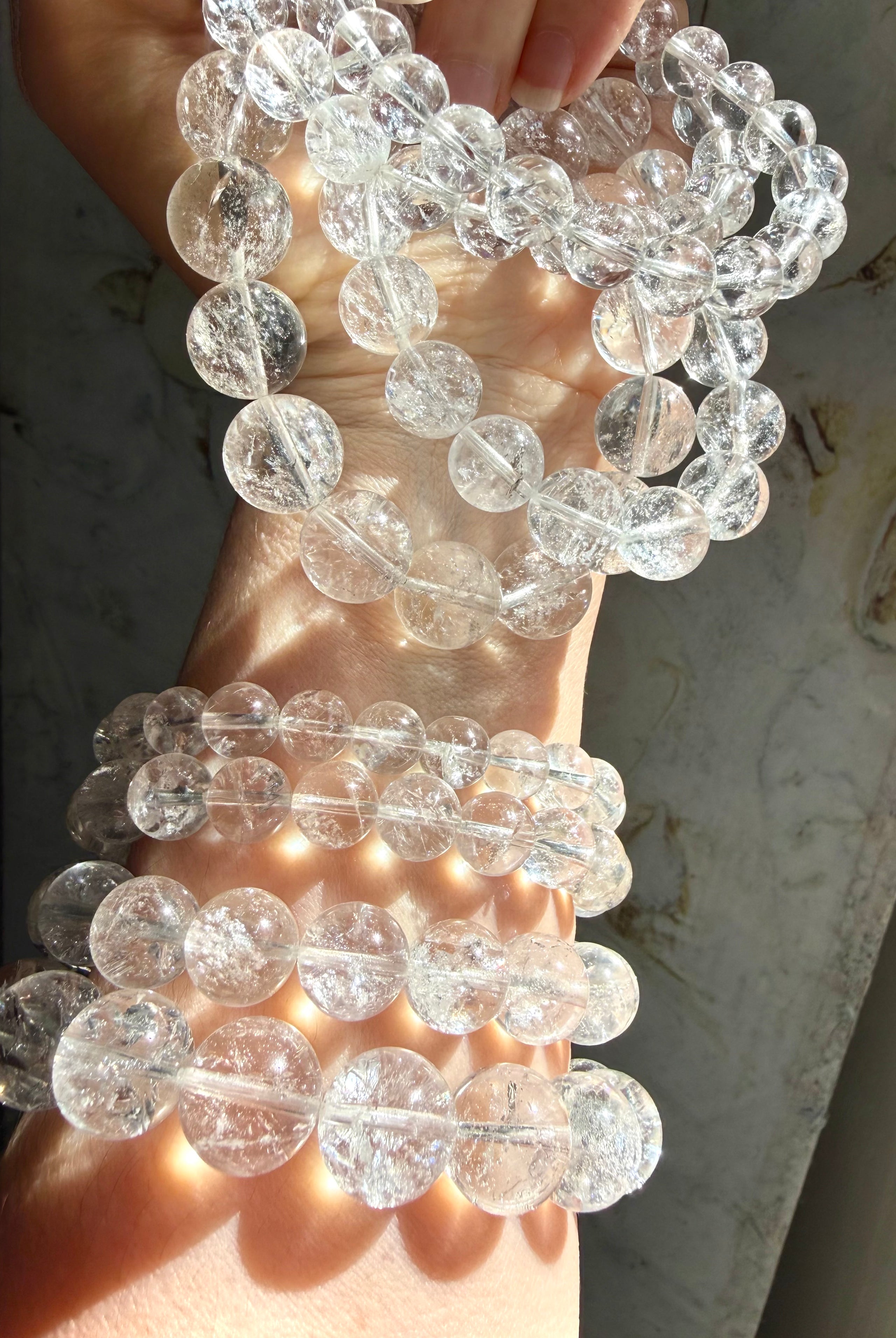 Rainbow Clear Quartz bracelet stack with high clarity crystal beads and luminous rainbow inclusions