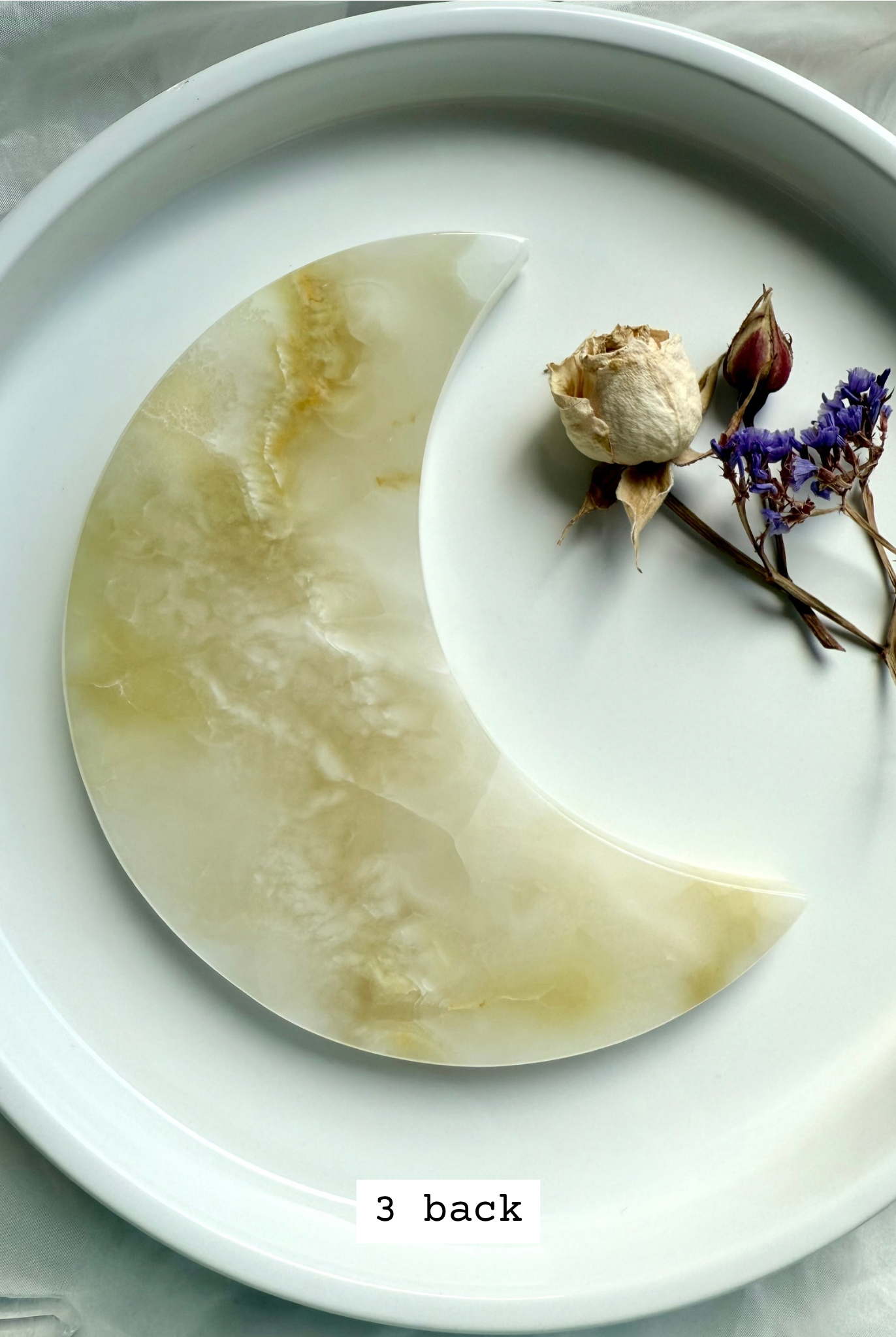 White Onyx Crescent Moon Plate, crystal carving with creamy white and subtle golden patterning, back view.