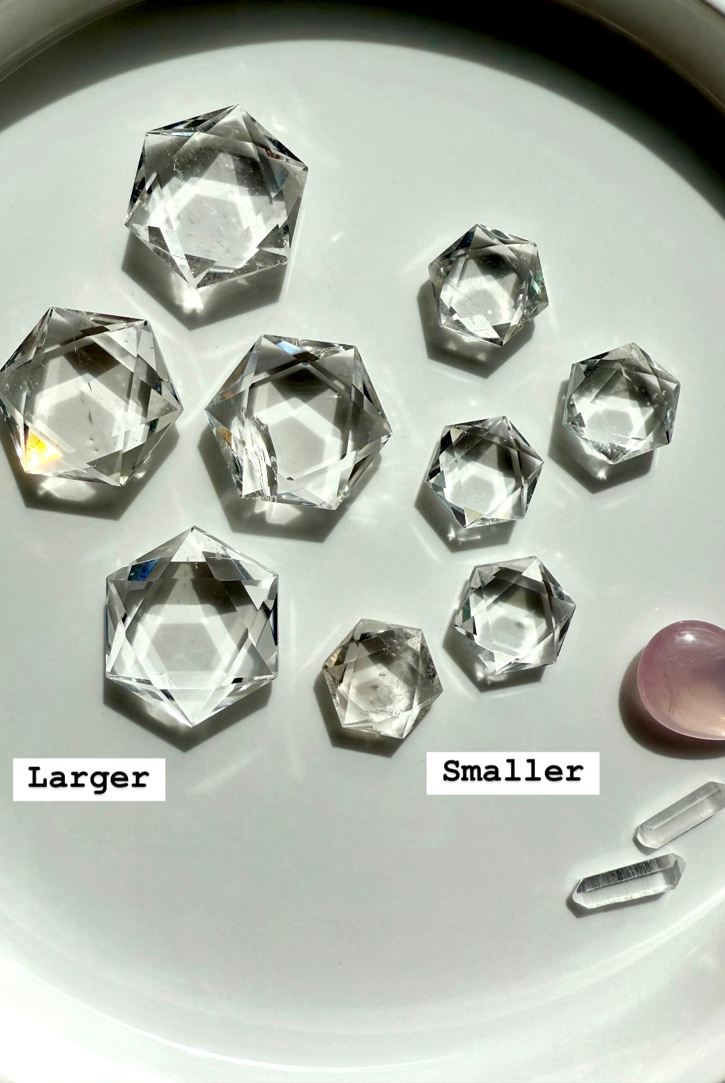 Overhead array of Clear Quartz hexagons in both sizes, smaller and larger marked for comparison