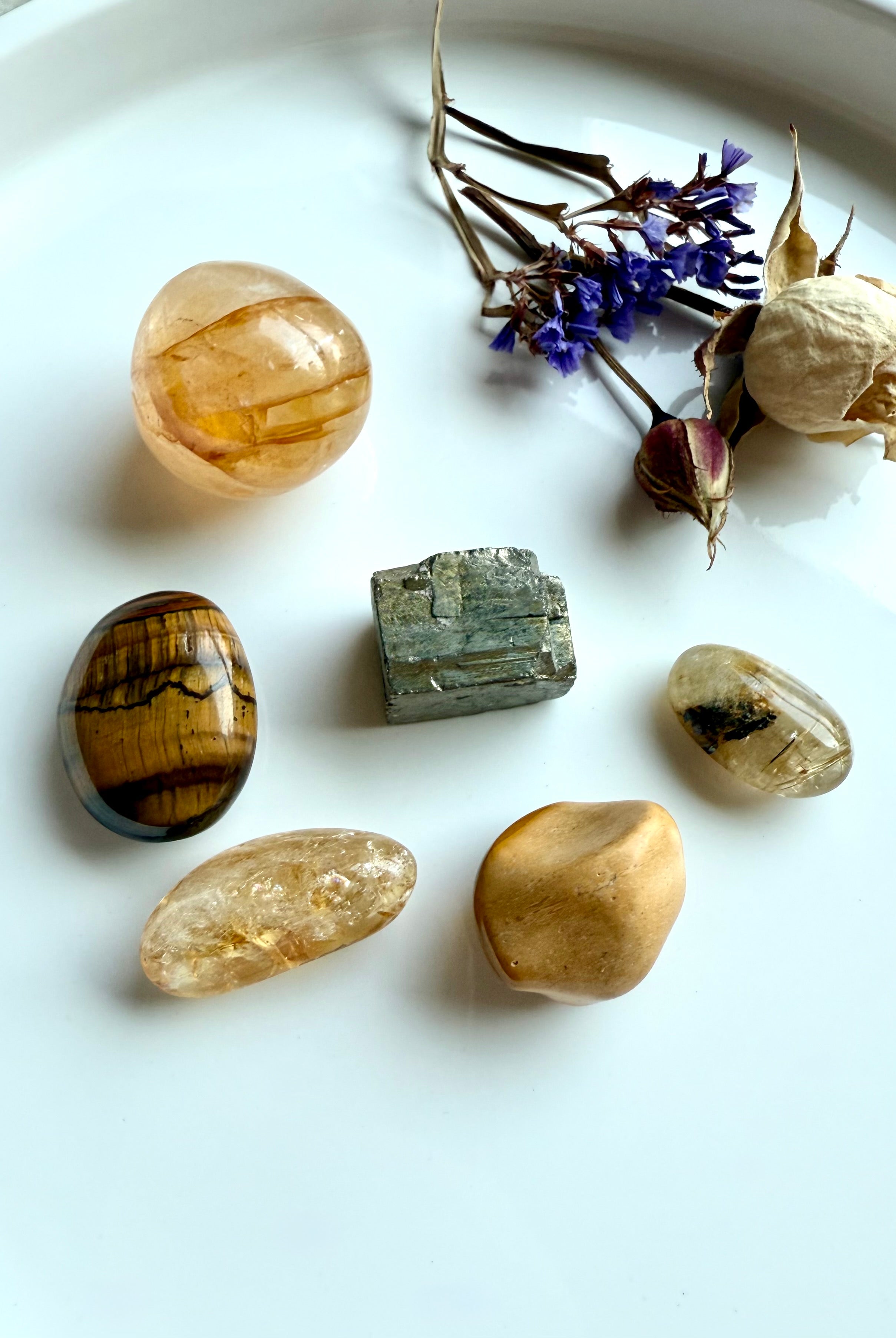 Solar Plexus Chakra crystal set with golden healer, citrine, golden rutile, tiger’s eye, yellow mookaite, and pyrite styled with flowers