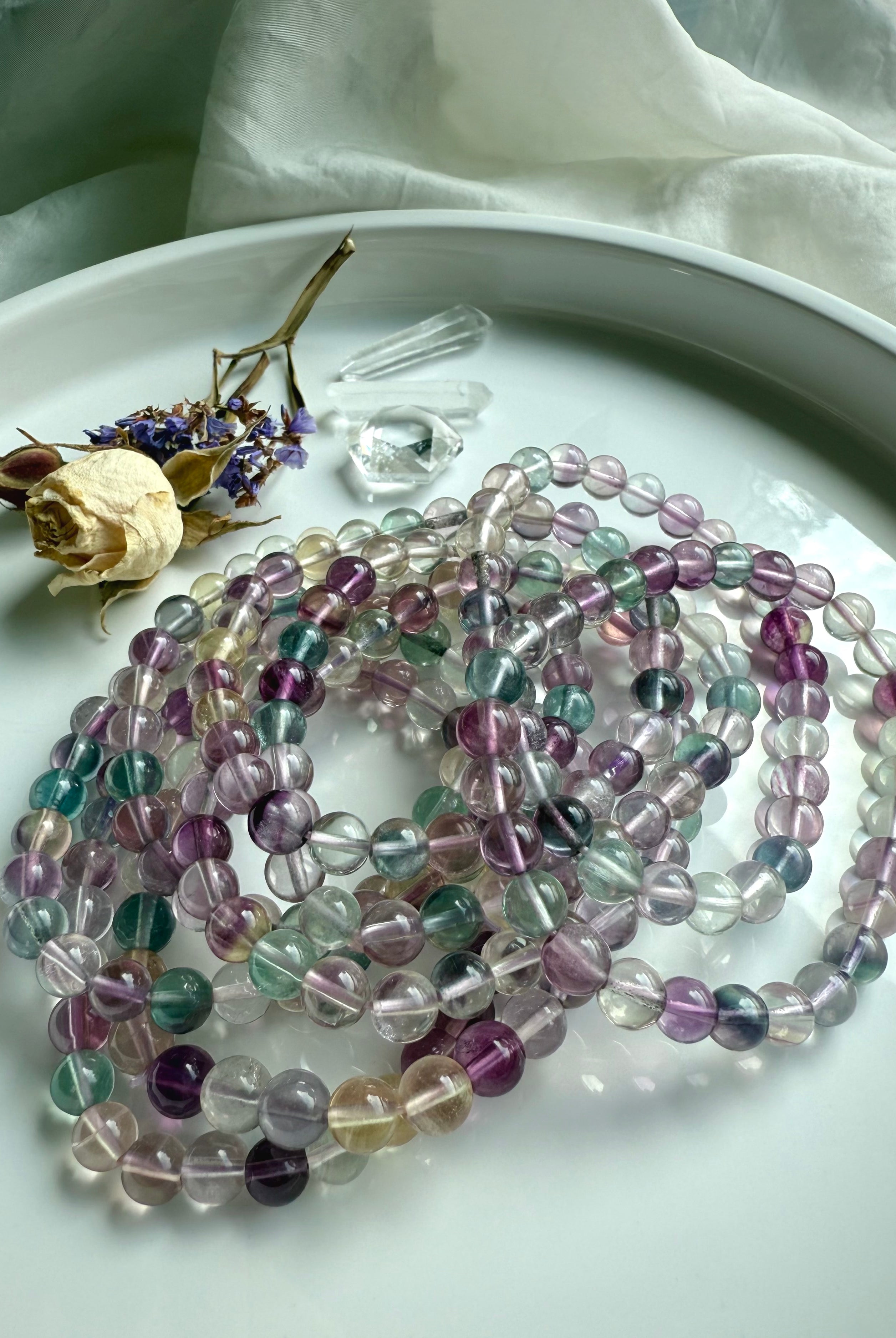 Fluorite crystal bracelets layered together to emphasize color harmony and energetic balance