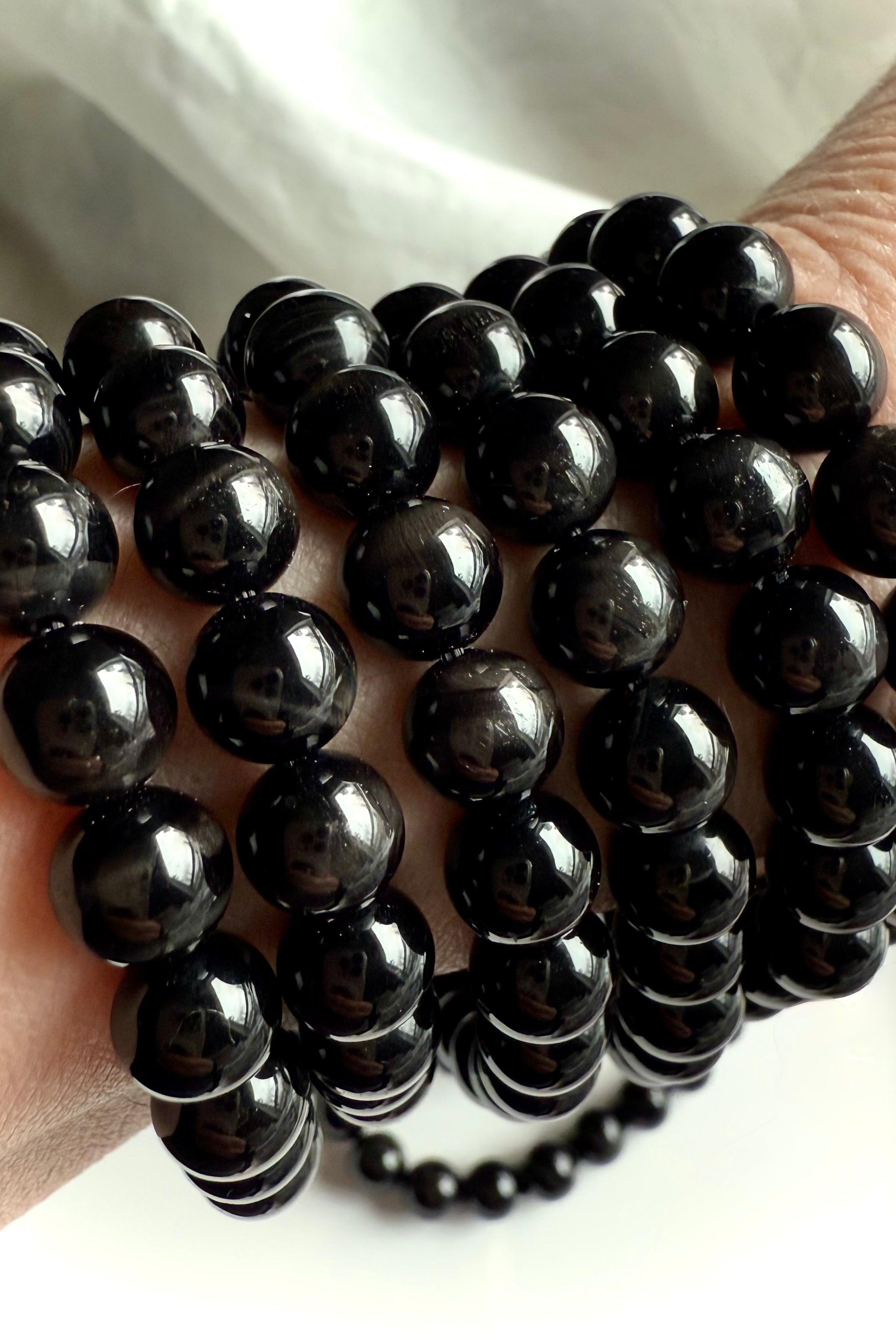 Black Tigers Eye Bracelet made from glossy black beads with tiger eye striations + cat’s eye shimmer