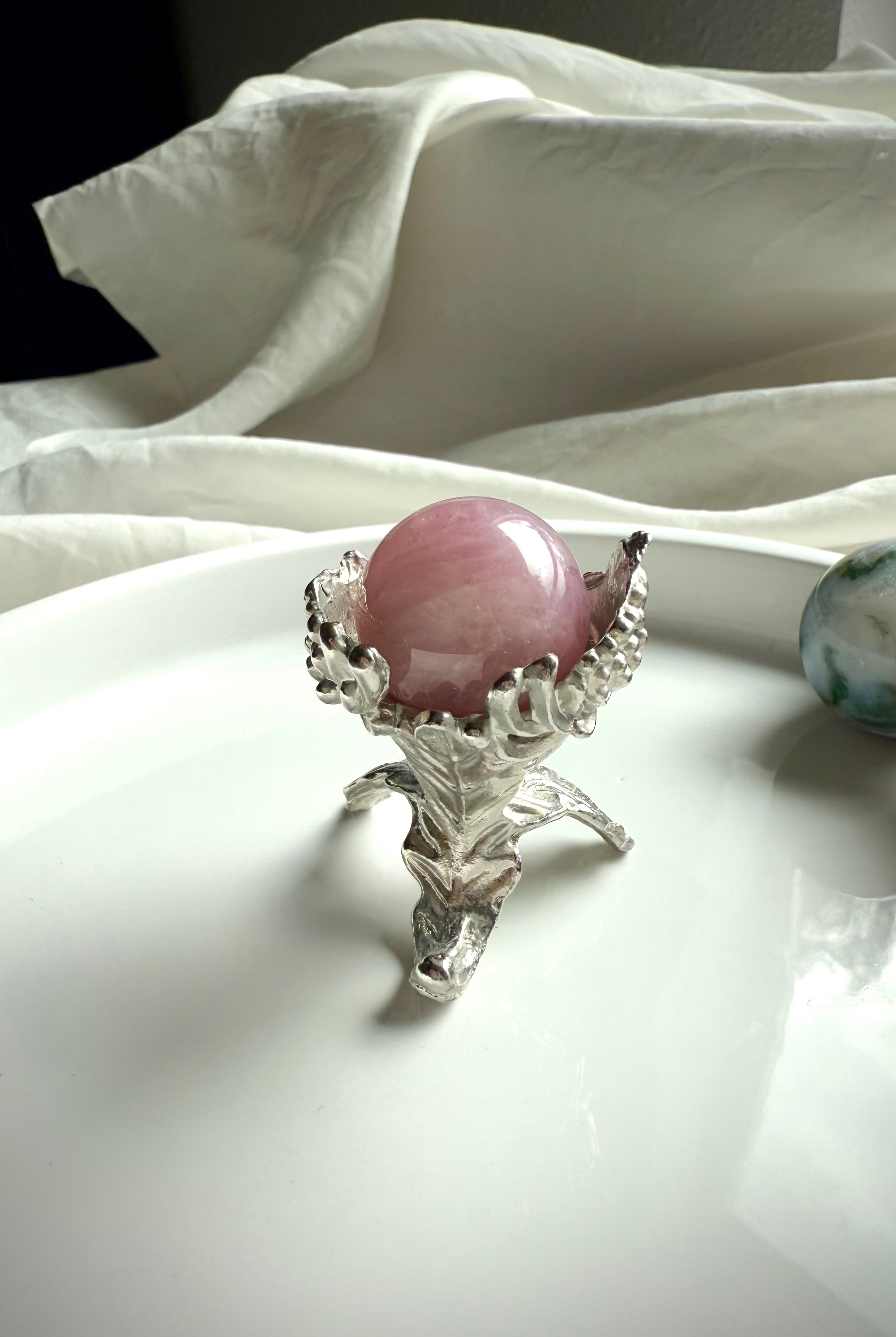 Our elegant botanical mini sphere stand fits small crystal spheres, shown with a rose quartz sphere