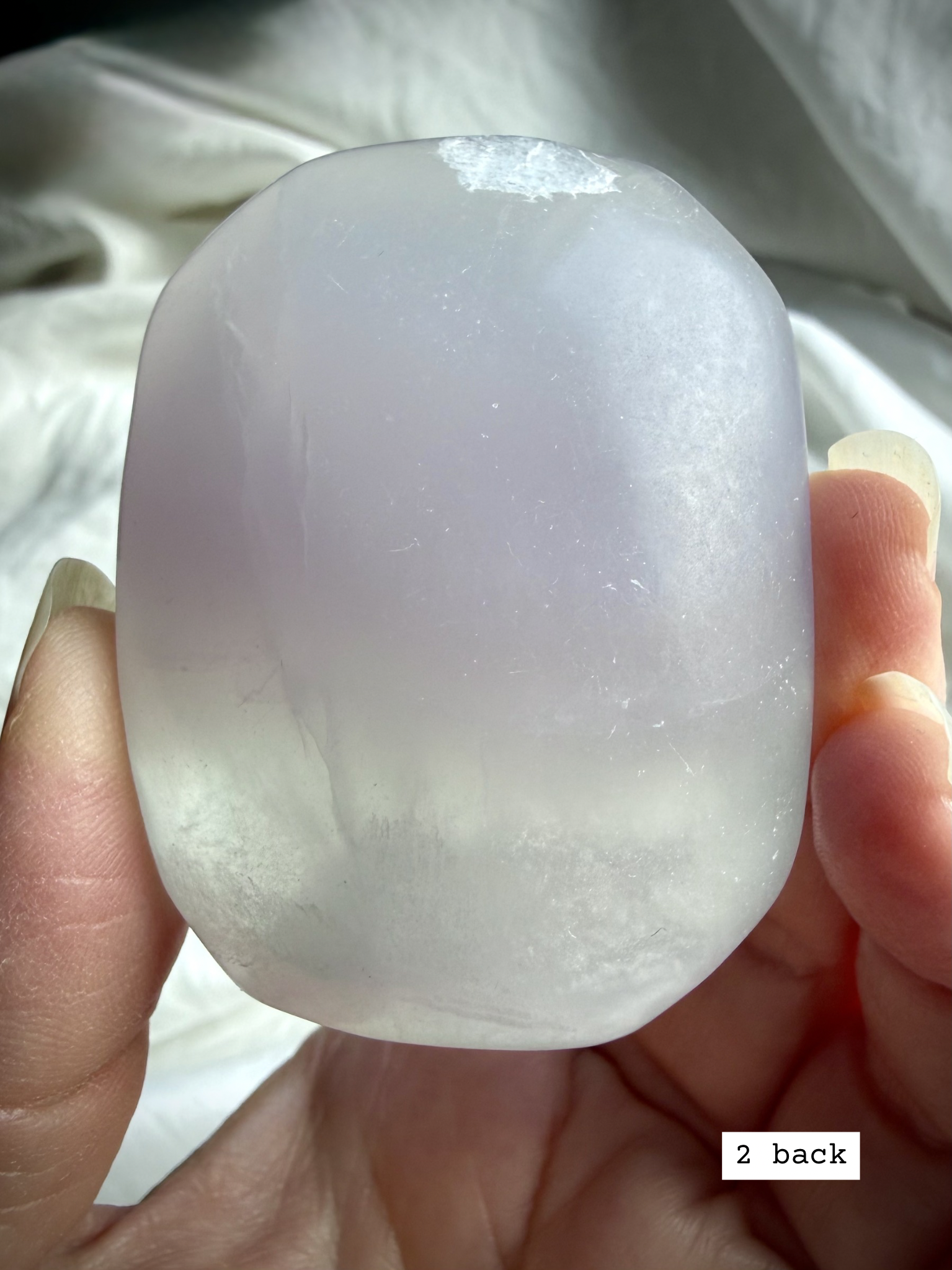 yttrium fluorite palm stone #2 back view showing natural inclusions and internal veils