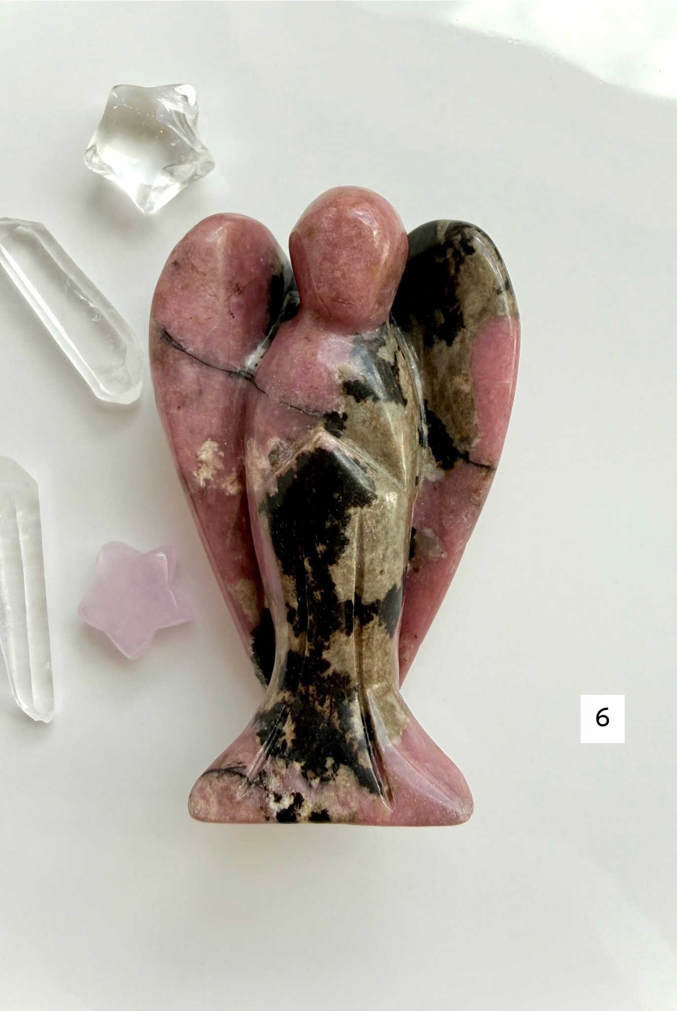 Natural Rhodonite angel carving with intricate matrix patterns and grounding energy