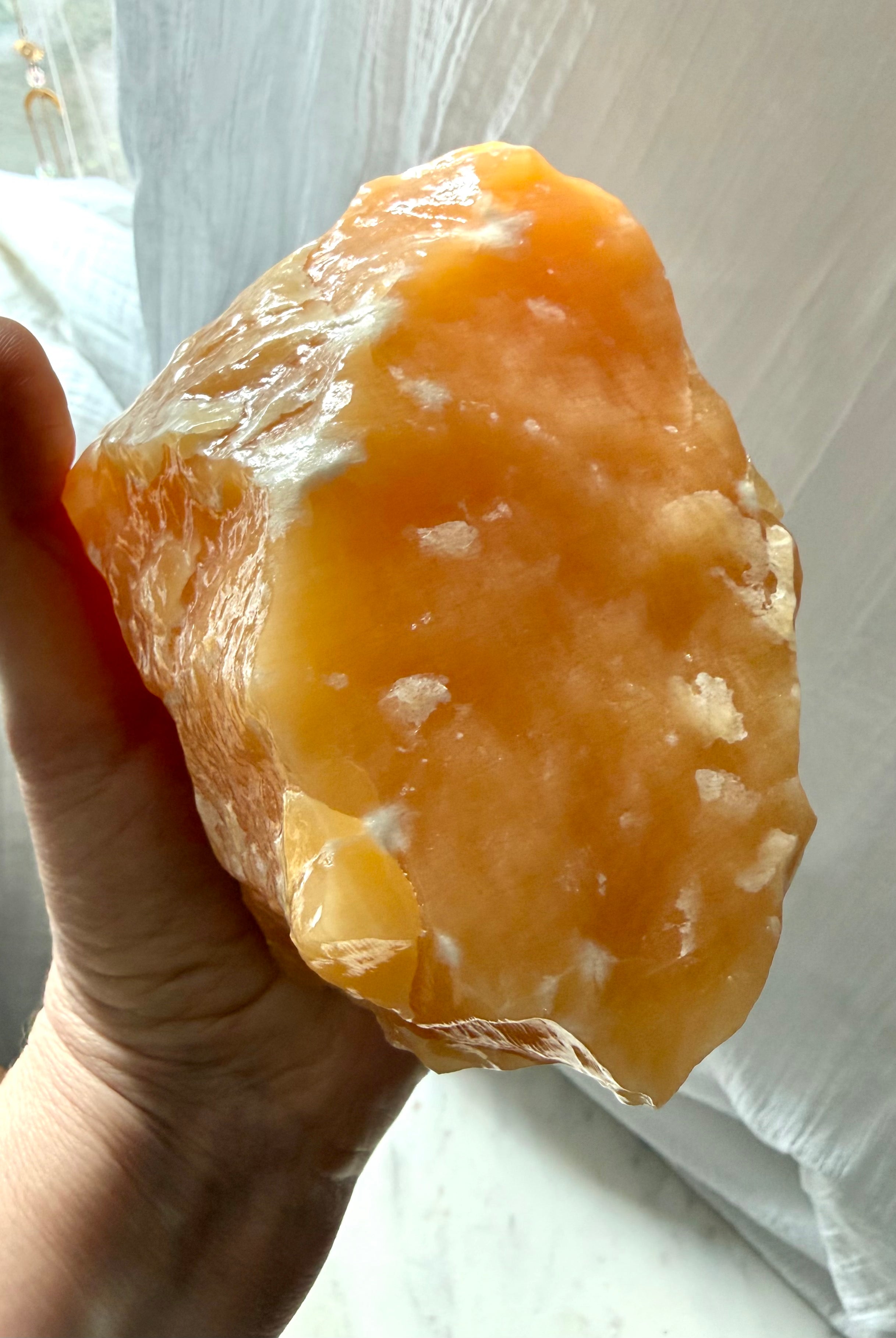 Orange Calcite statement piece from Mexico with glowing orange color and self-standing display shape