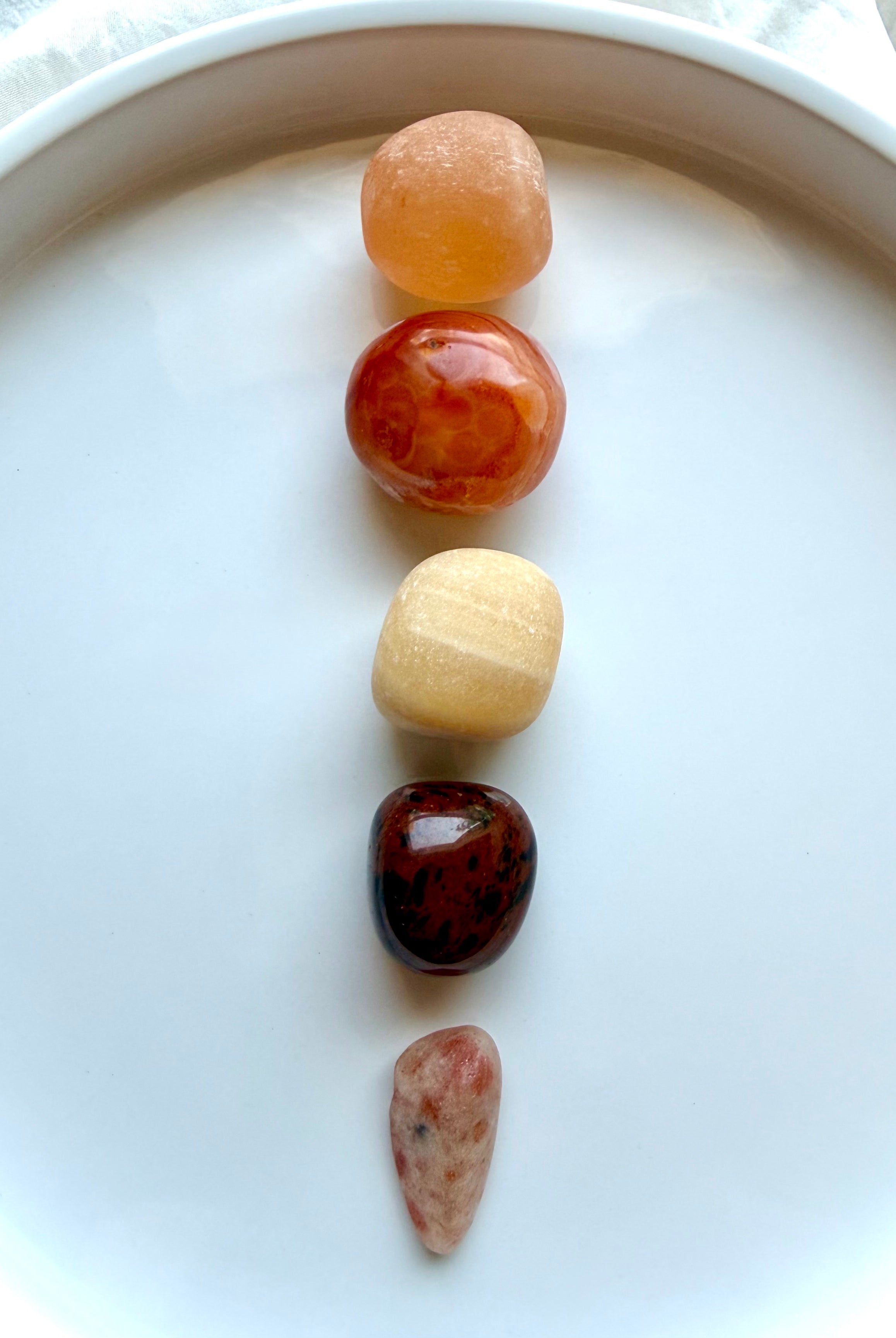 Five Sacral Chakra crystals arranged vertically for creativity, emotional balance, personal power, and energy healing