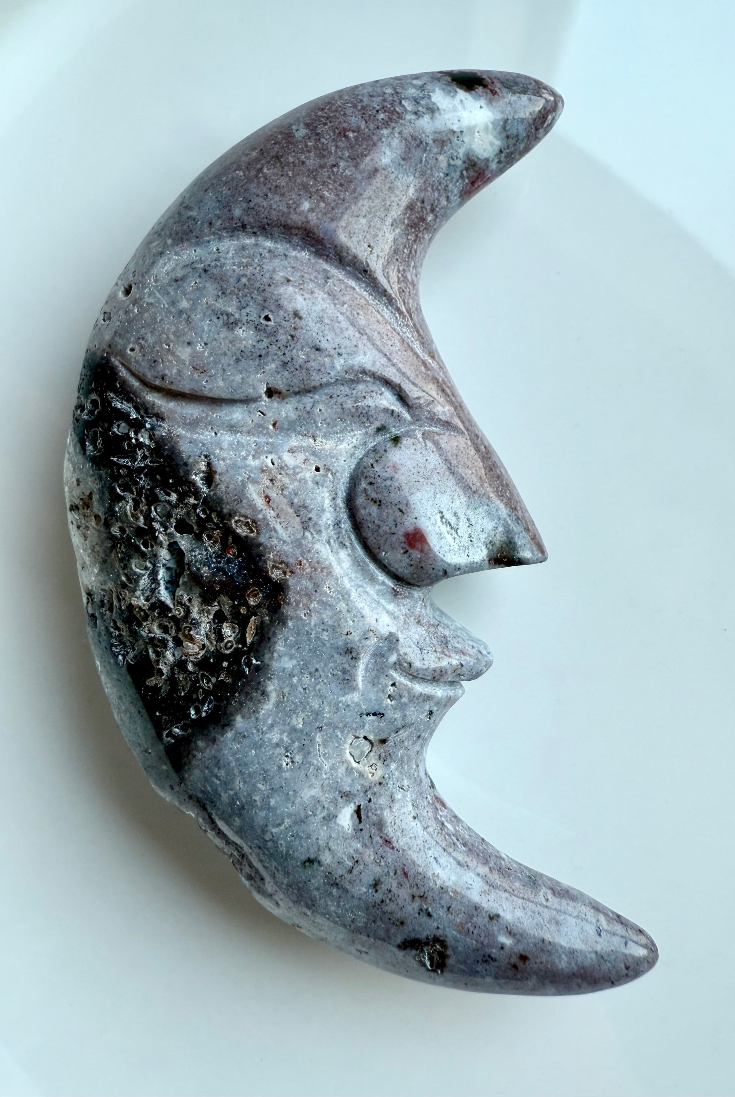 Polished Ocean Jasper moon face crystal in purple hues – carved gemstone with swirling inclusions.