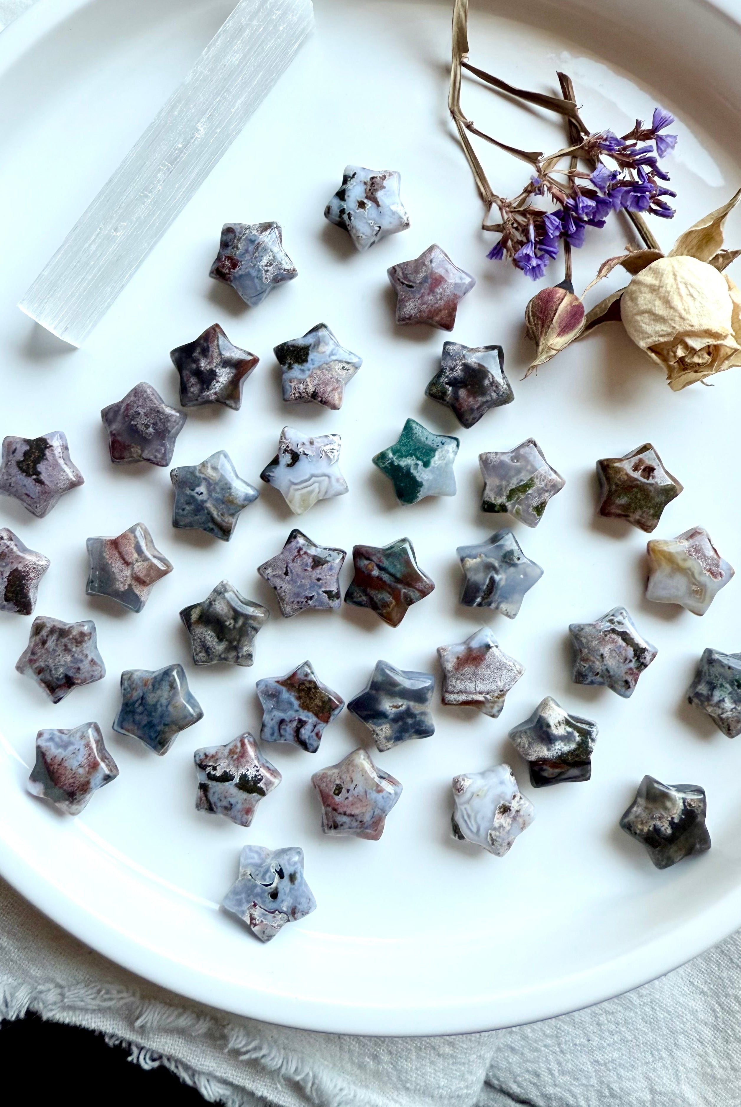 Ocean Jasper star carvings displayed with selenite and dried flowers, mini gemstone stars for healing, ritual, and sacred space decoration
