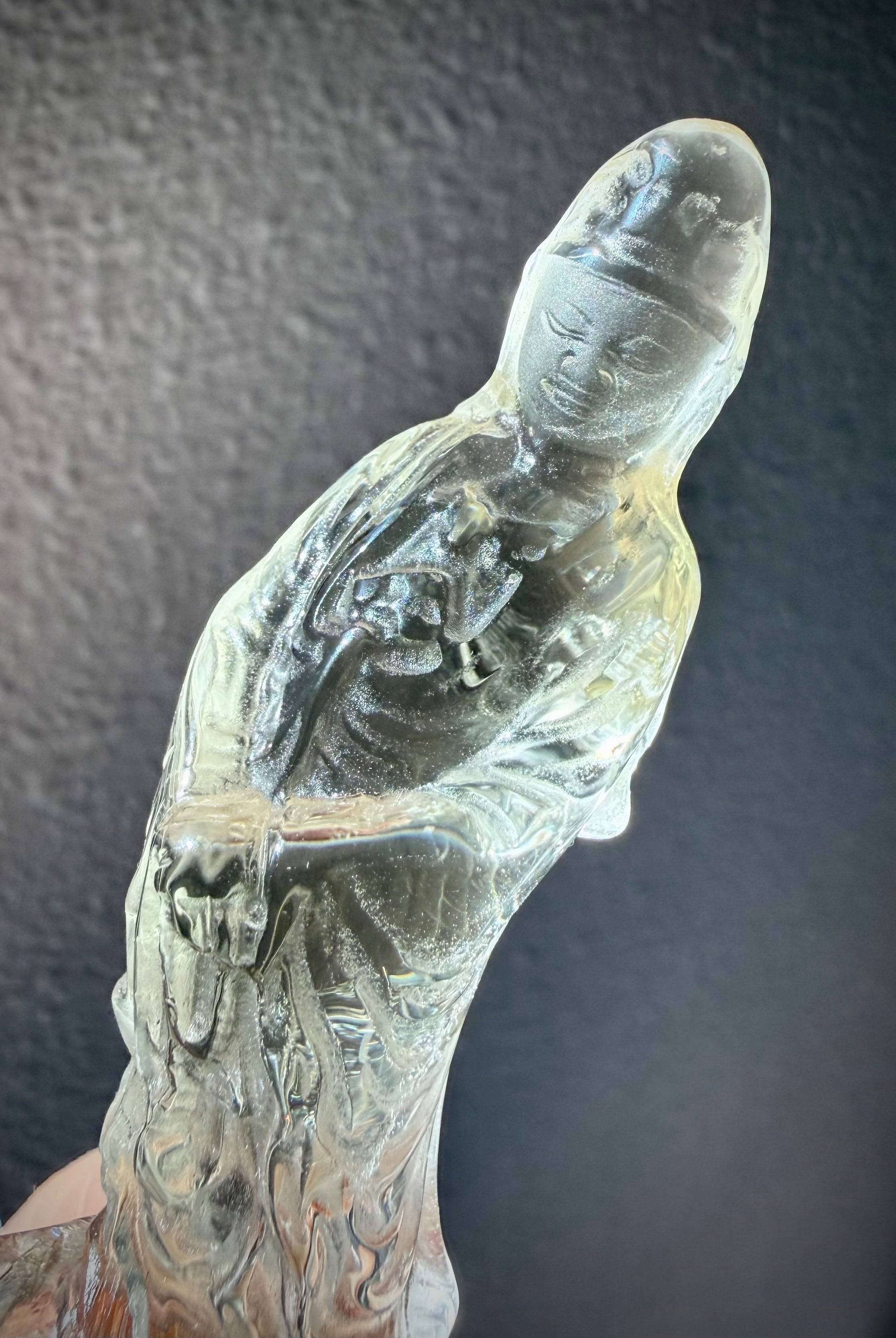closeup of Citrine Quan Yin crystal carving with serene expression and translucent golden tones