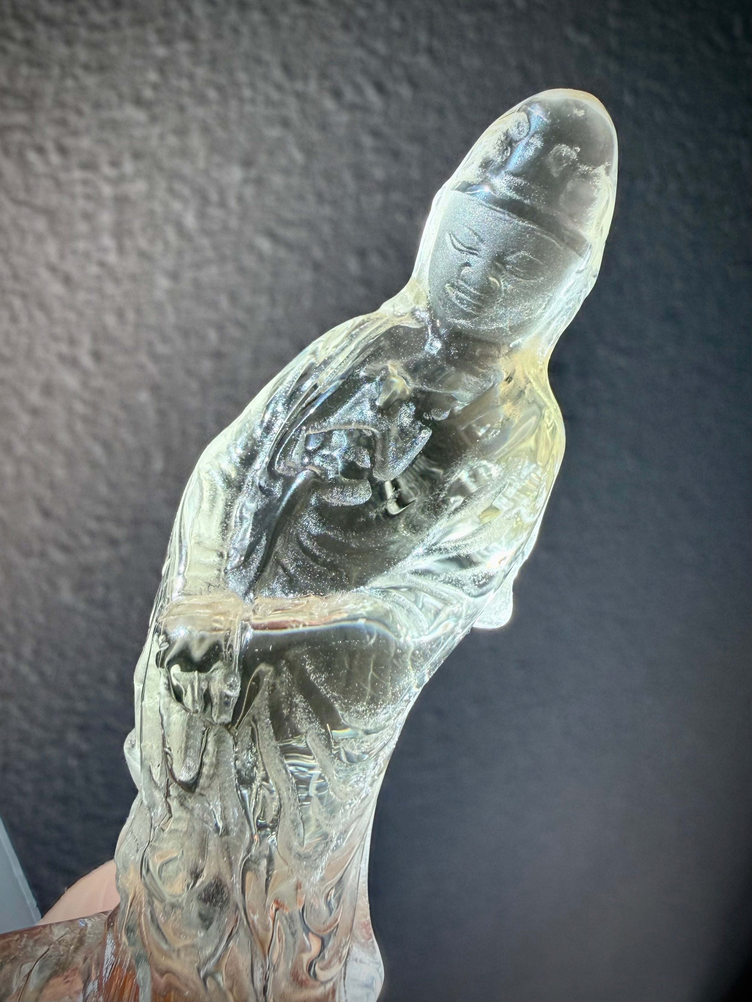 closeup of Citrine Quan Yin crystal carving with serene expression and translucent golden tones