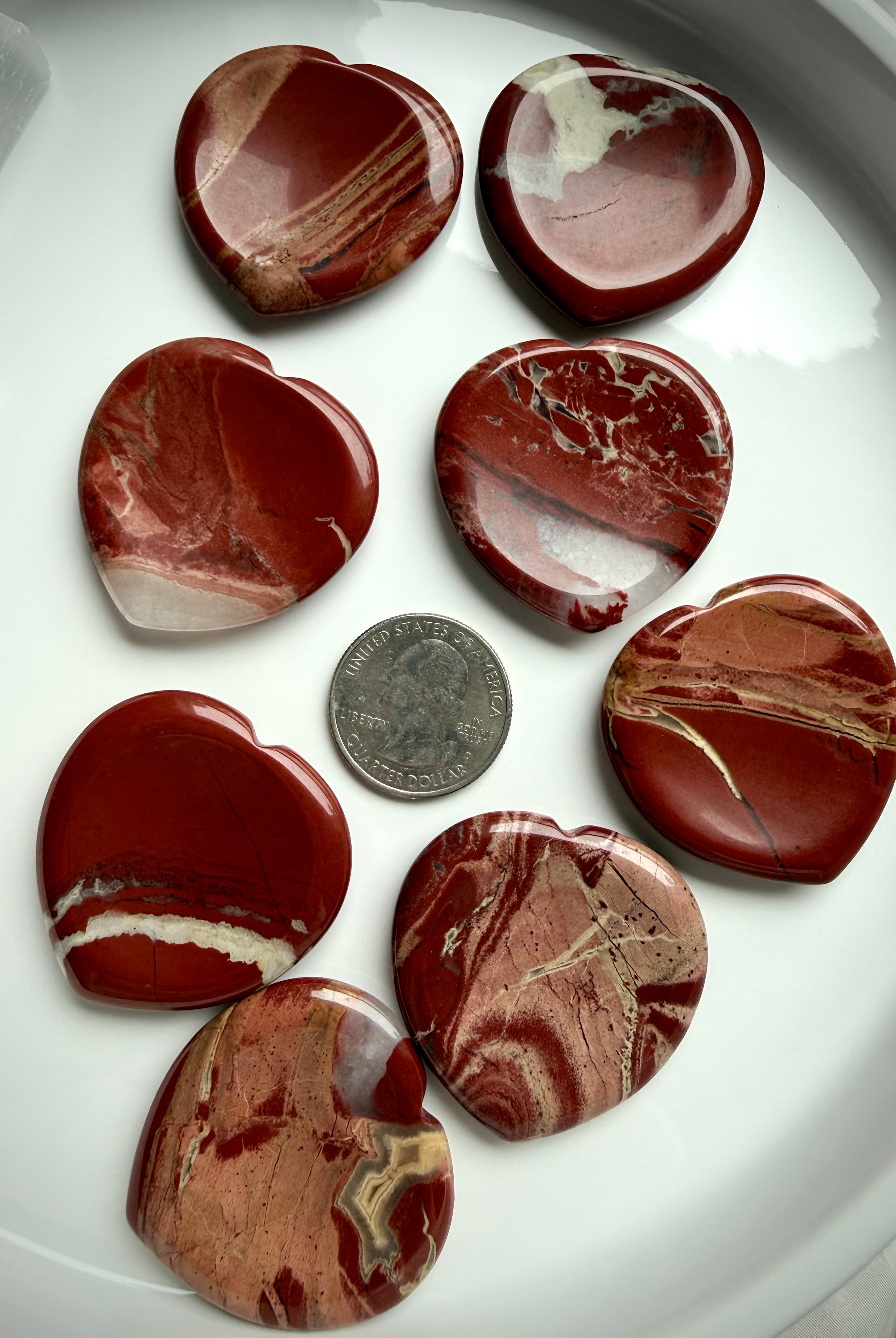 red jasper heart worry stones on tray with quarter for scale – polished grounding crystal for Root Chakra stability