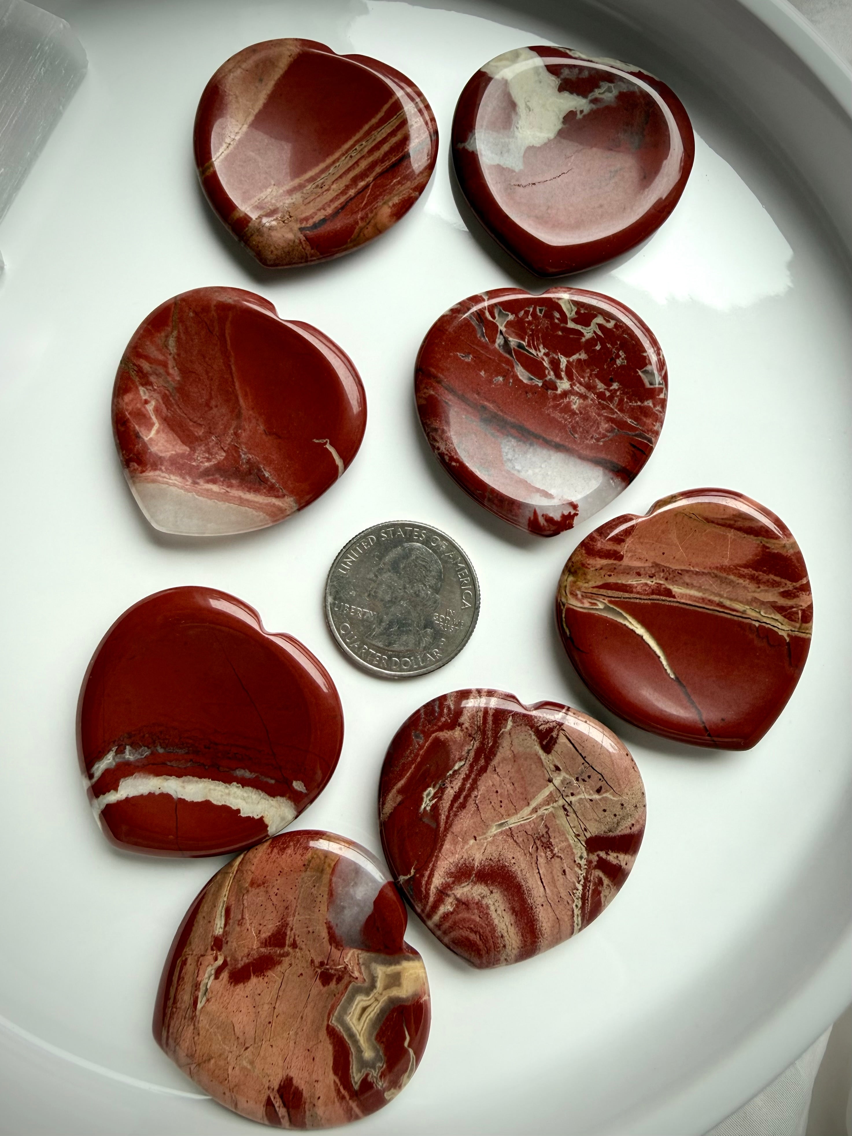 red jasper heart worry stones on tray with quarter for scale – polished grounding crystal for Root Chakra stability