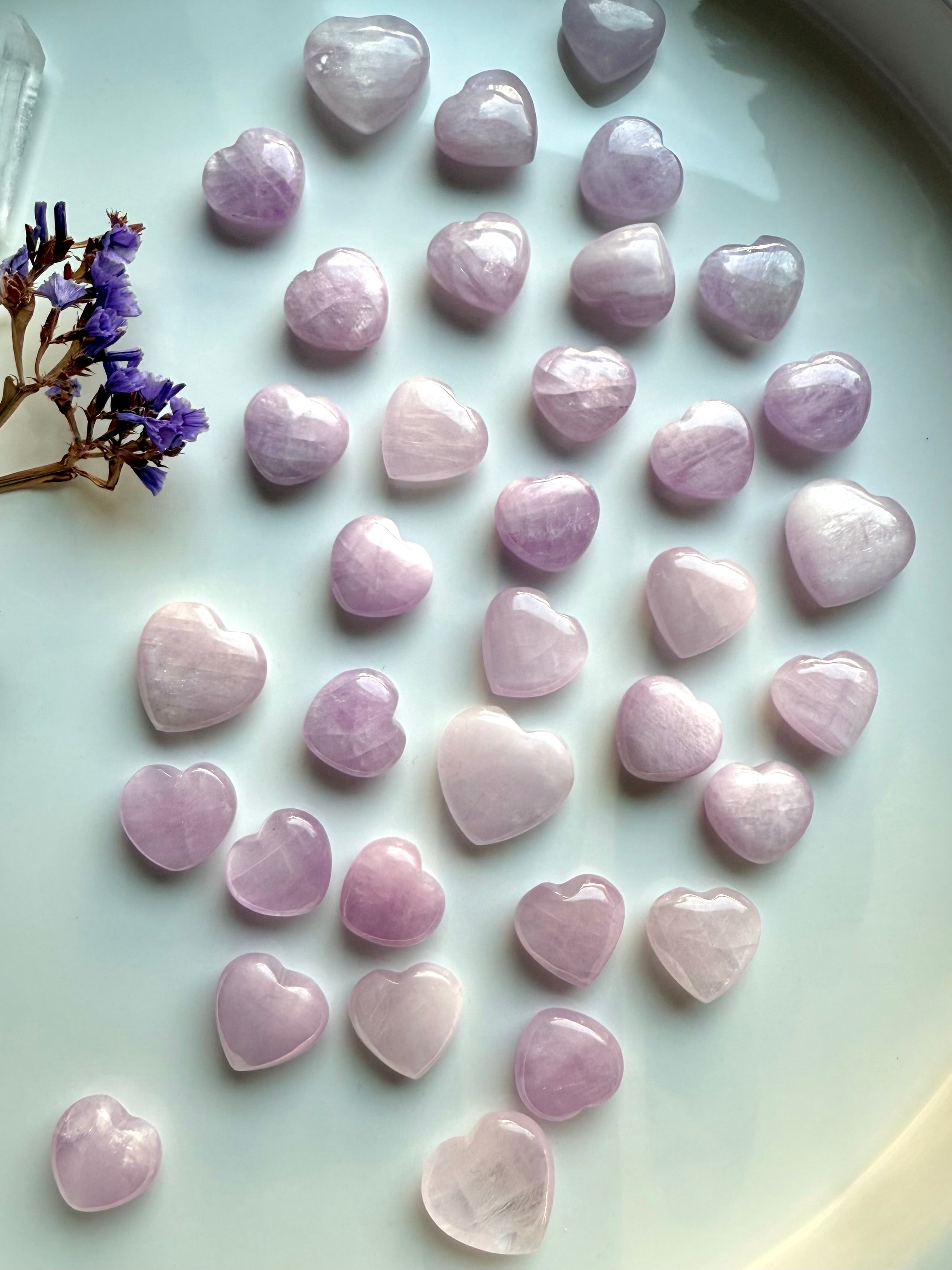 Wide shot of Pink Kunzite mini hearts on a white background β soft pink crystal hearts for love, calm & intentional energy work.