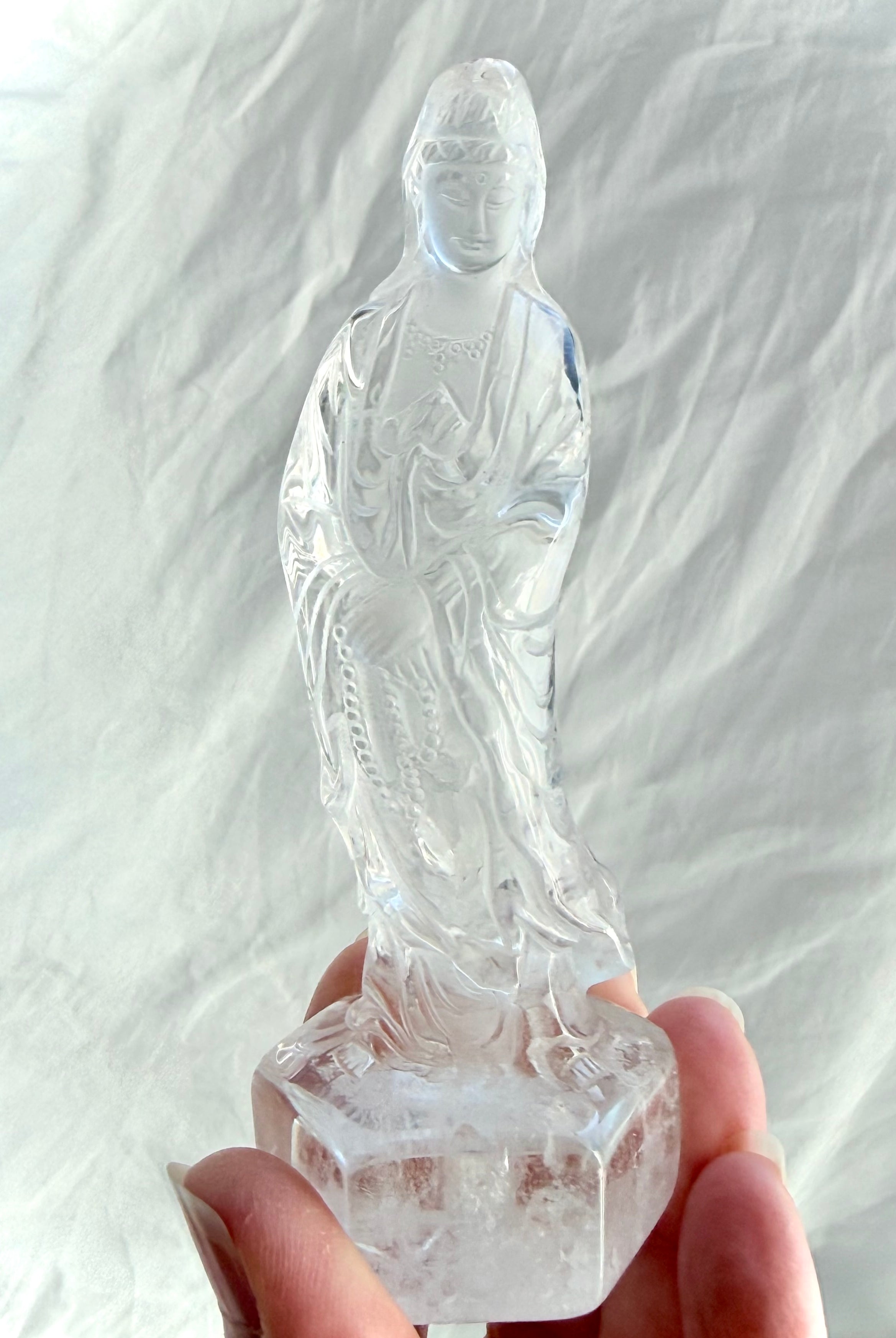 Clear Quartz Quan Yin statue carved from luminous crystal with exceptional clarity and serene goddess details