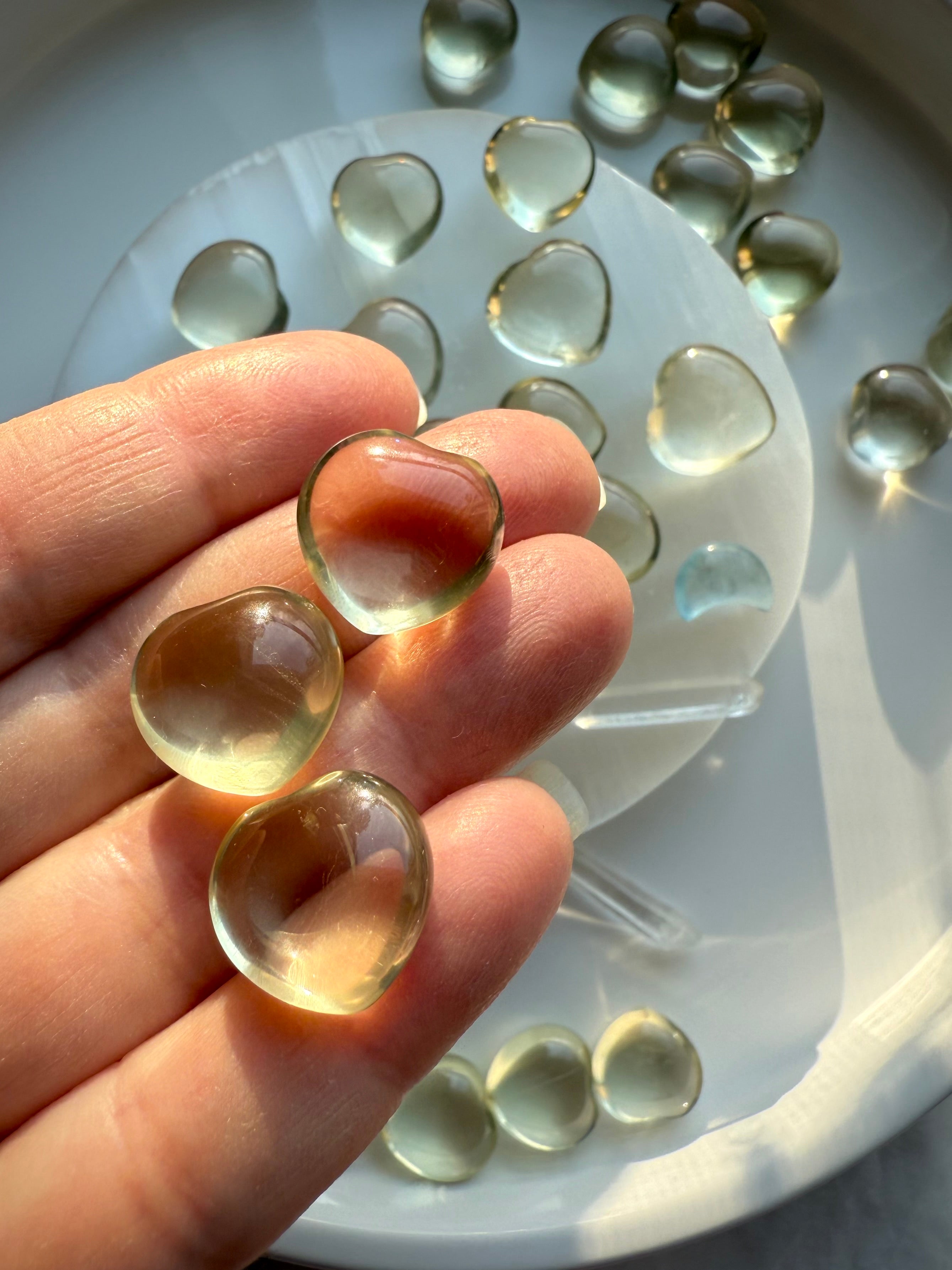 Mini Lemon Citrine heart crystals held in hand, small polished citrine gemstone for confidence, happiness, and Solar Plexus balance