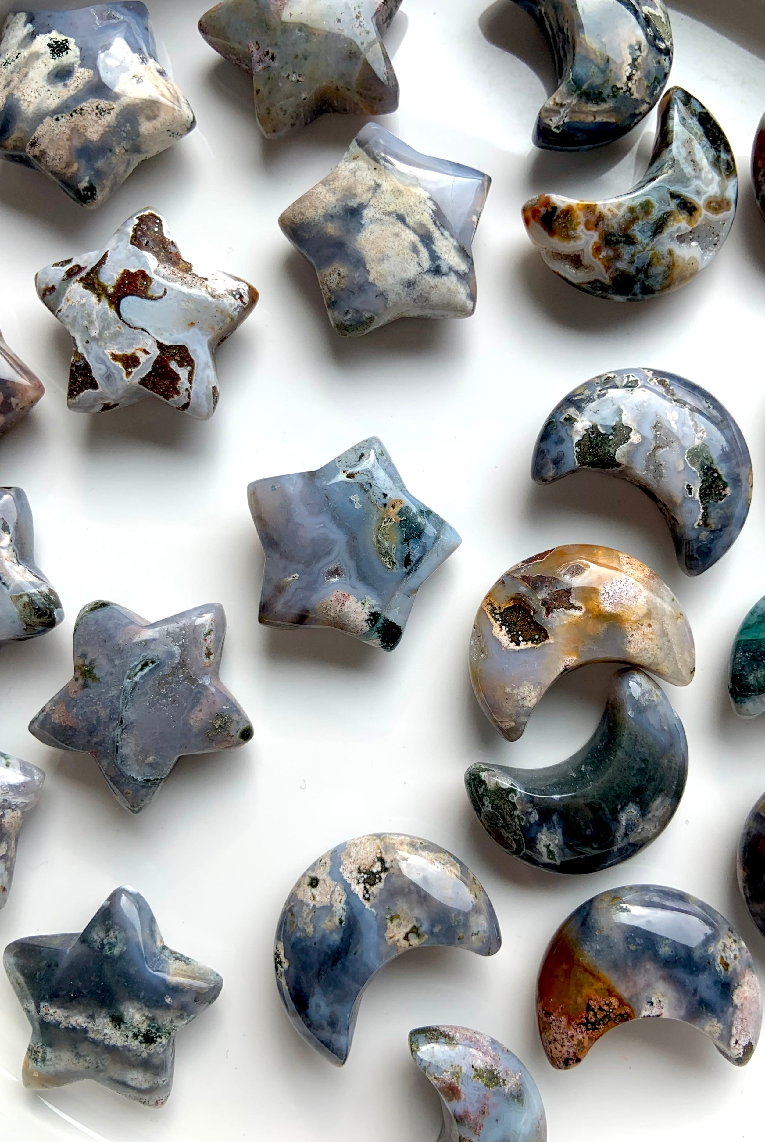 Closeup of Cosmic Ocean Jasper moons and stars carvings for crystal healing