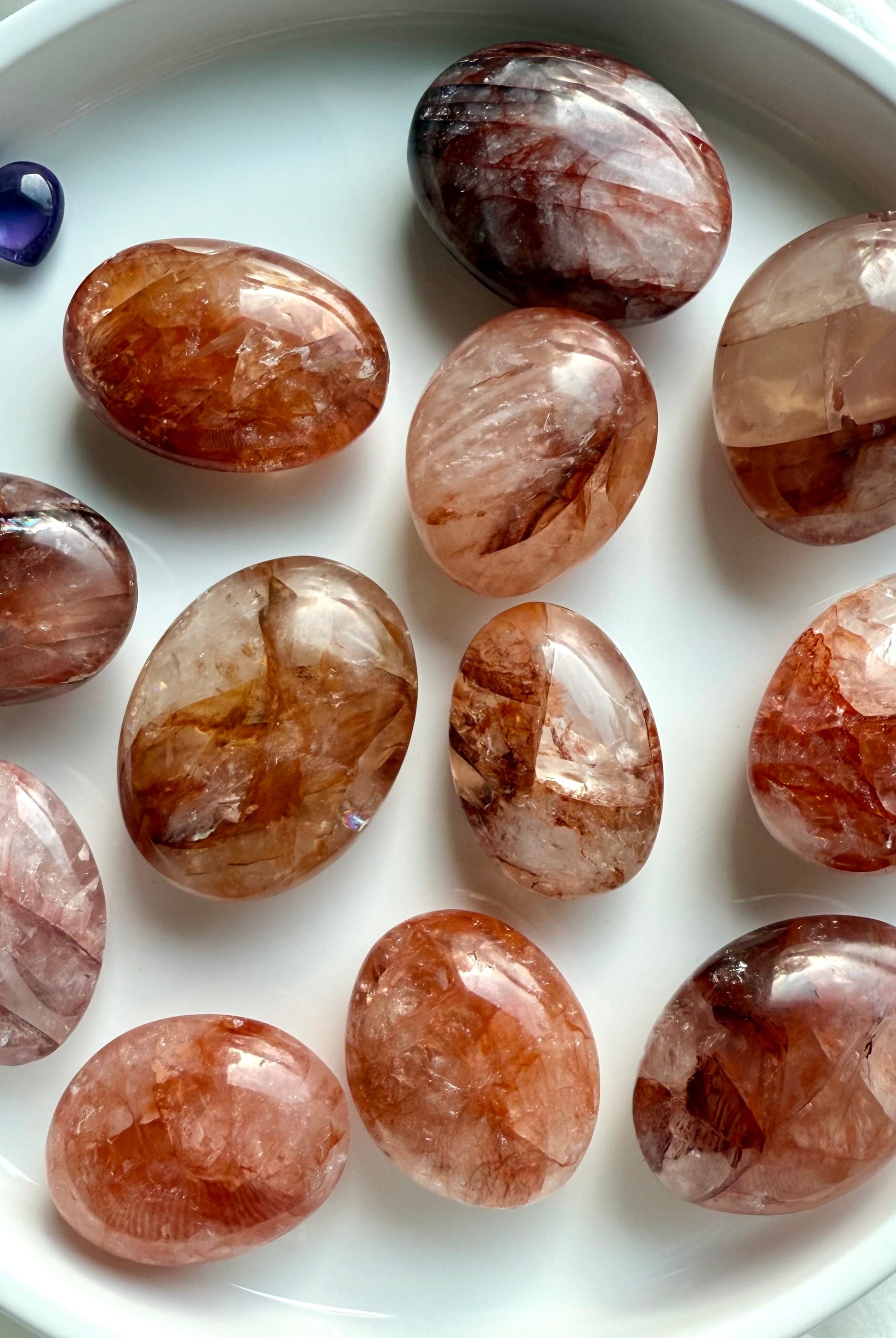 Collection of Fire Quartz palm stones with unique hematite patterns for courage, focus, and grounding