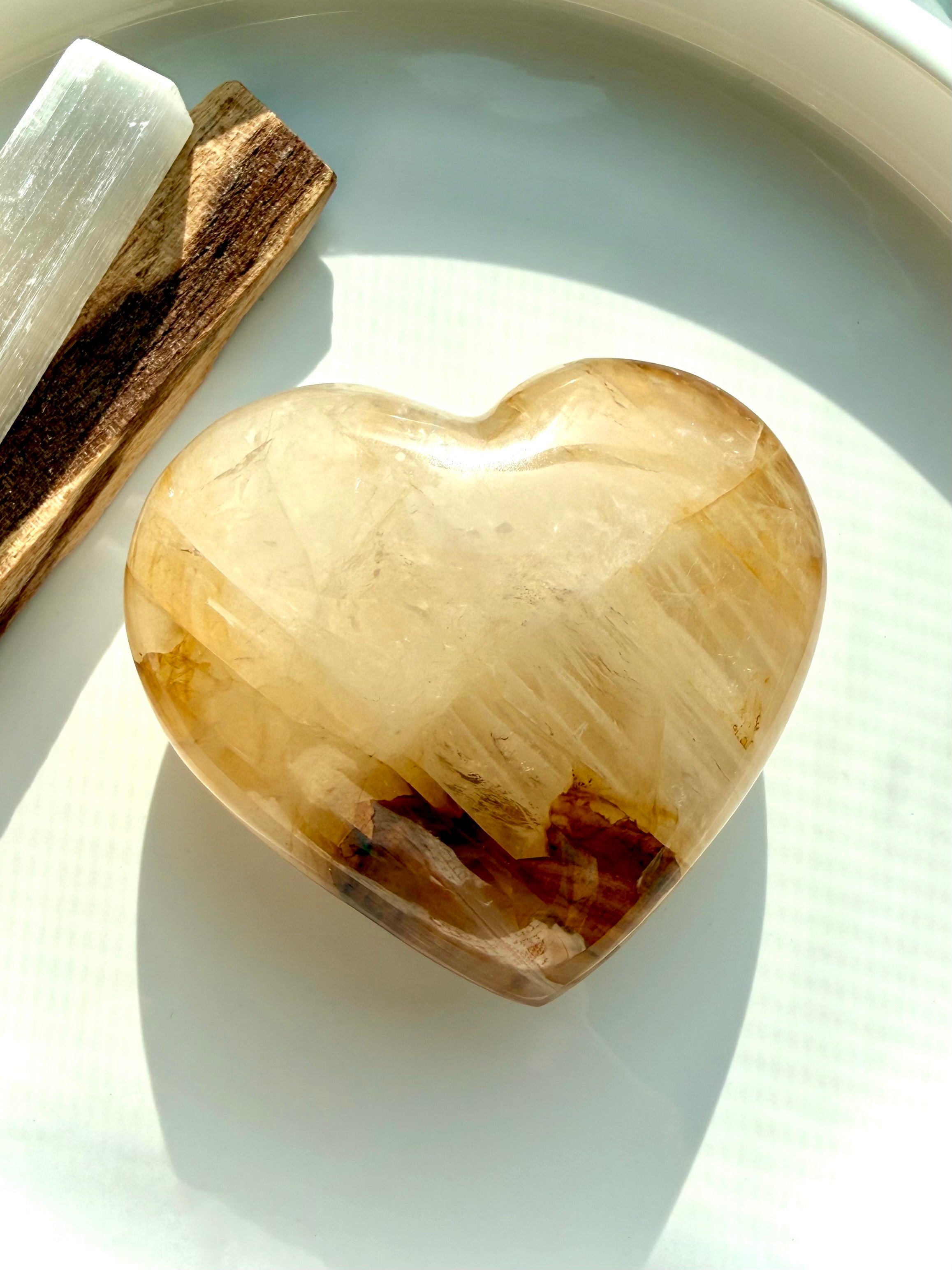 Golden Healer quartz heart with palo santo and selenite crystal for energy clearing, empowerment, and manifestation rituals