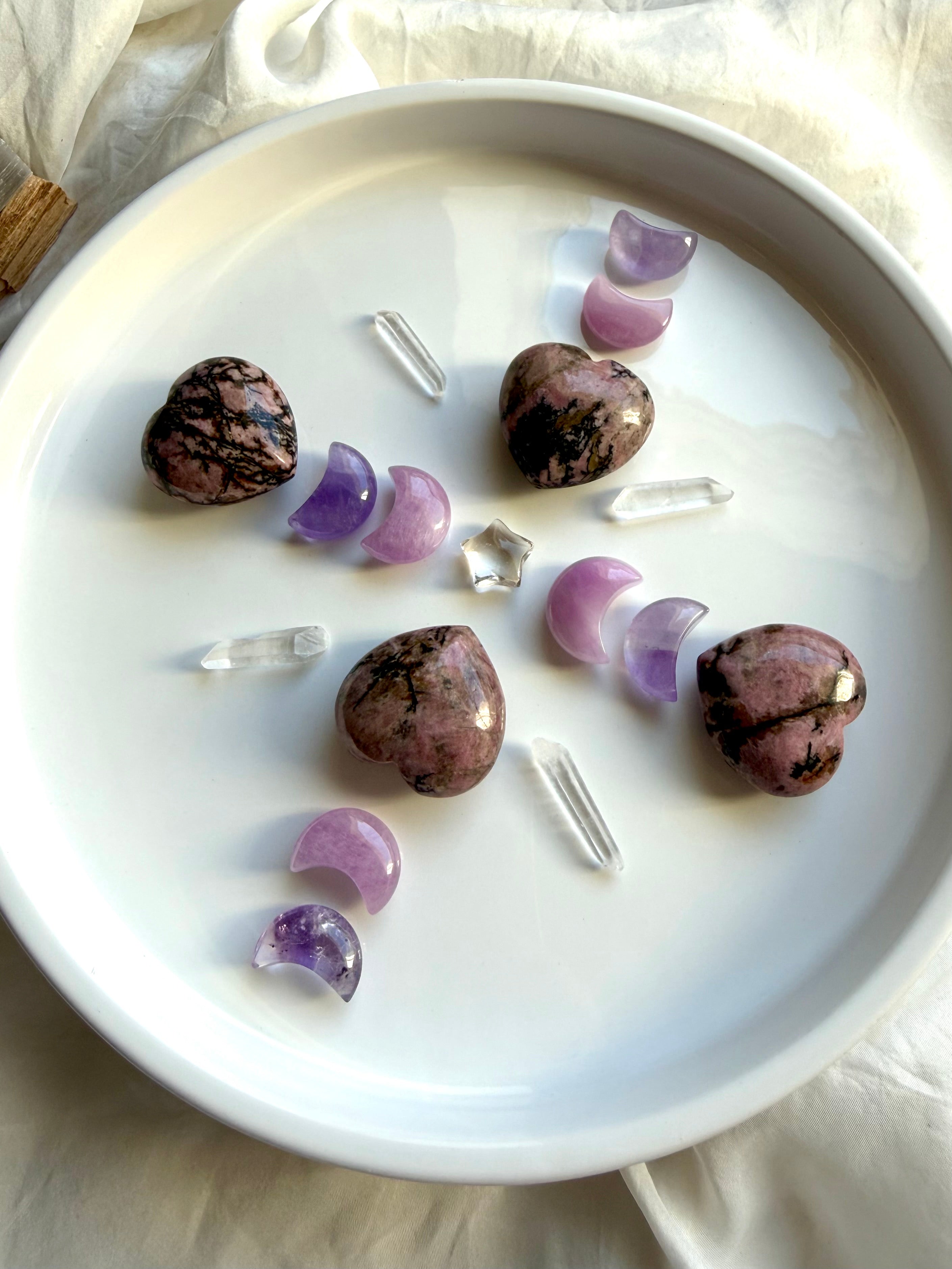 Rhodonite hearts with Amethyst and Kunzite moons, Clear Quartz points and crystal star in a Heart Chakra crystal grid