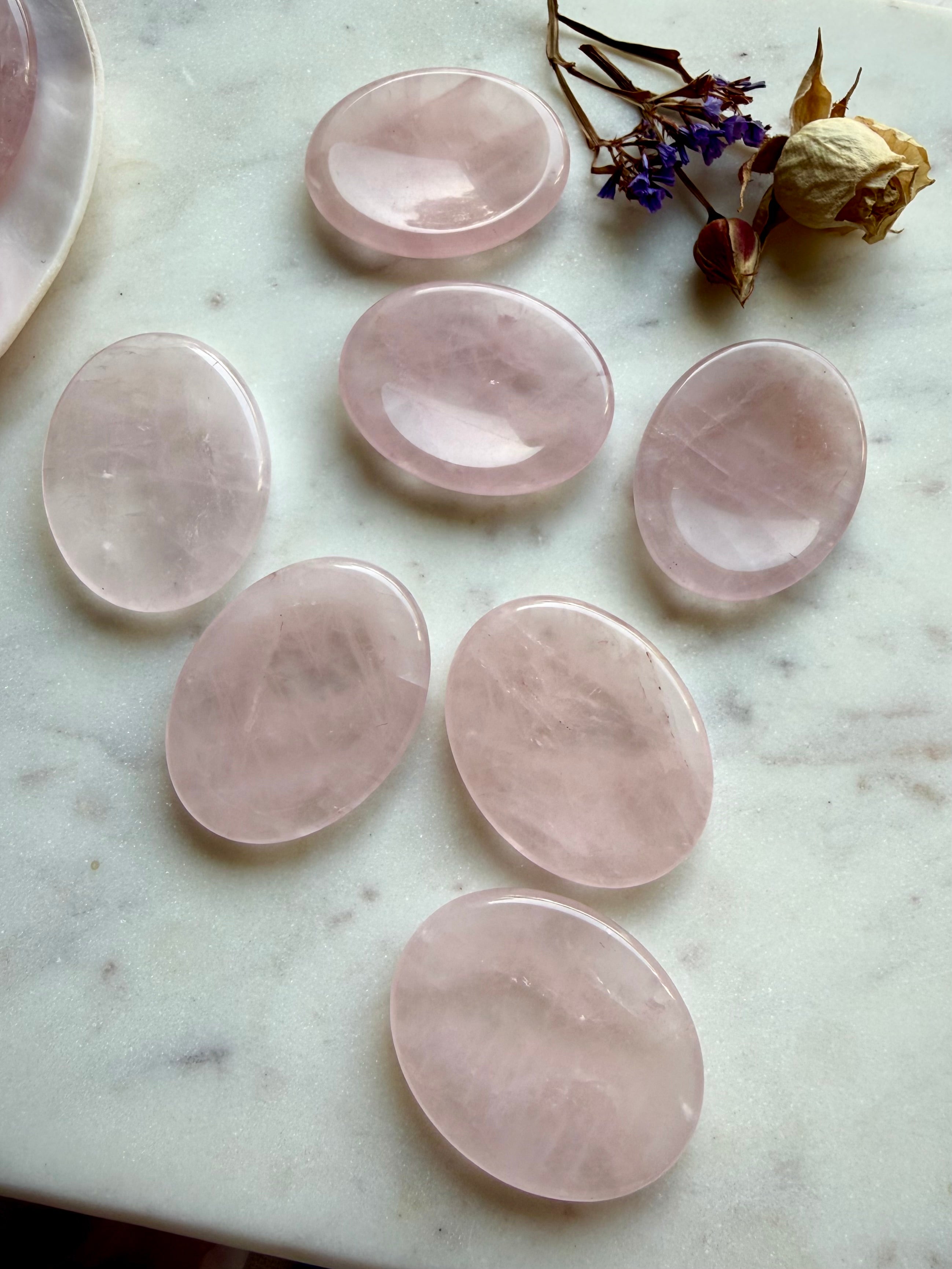 rose quartz worry stones arranged on marble for anxiety relief meditation and heart chakra support