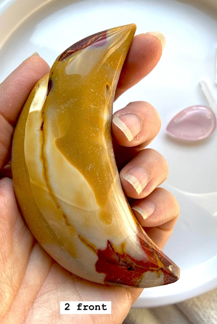 Closeup of Mookaite jasper moon # 2 shown in hand, front side