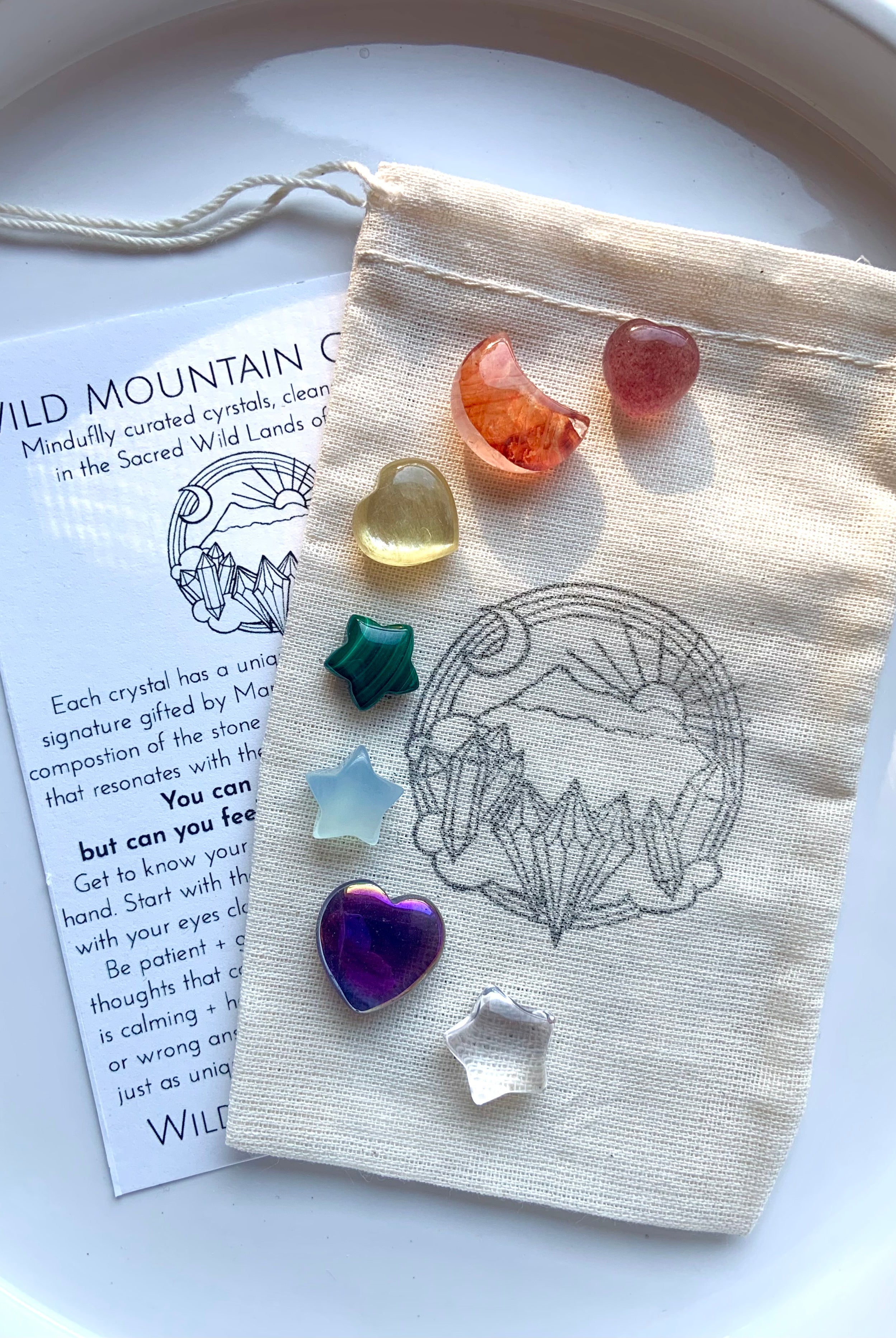 Chakra crystal set with 7 mini carved gems — heart, moon & star shapes in rainbow colors with info