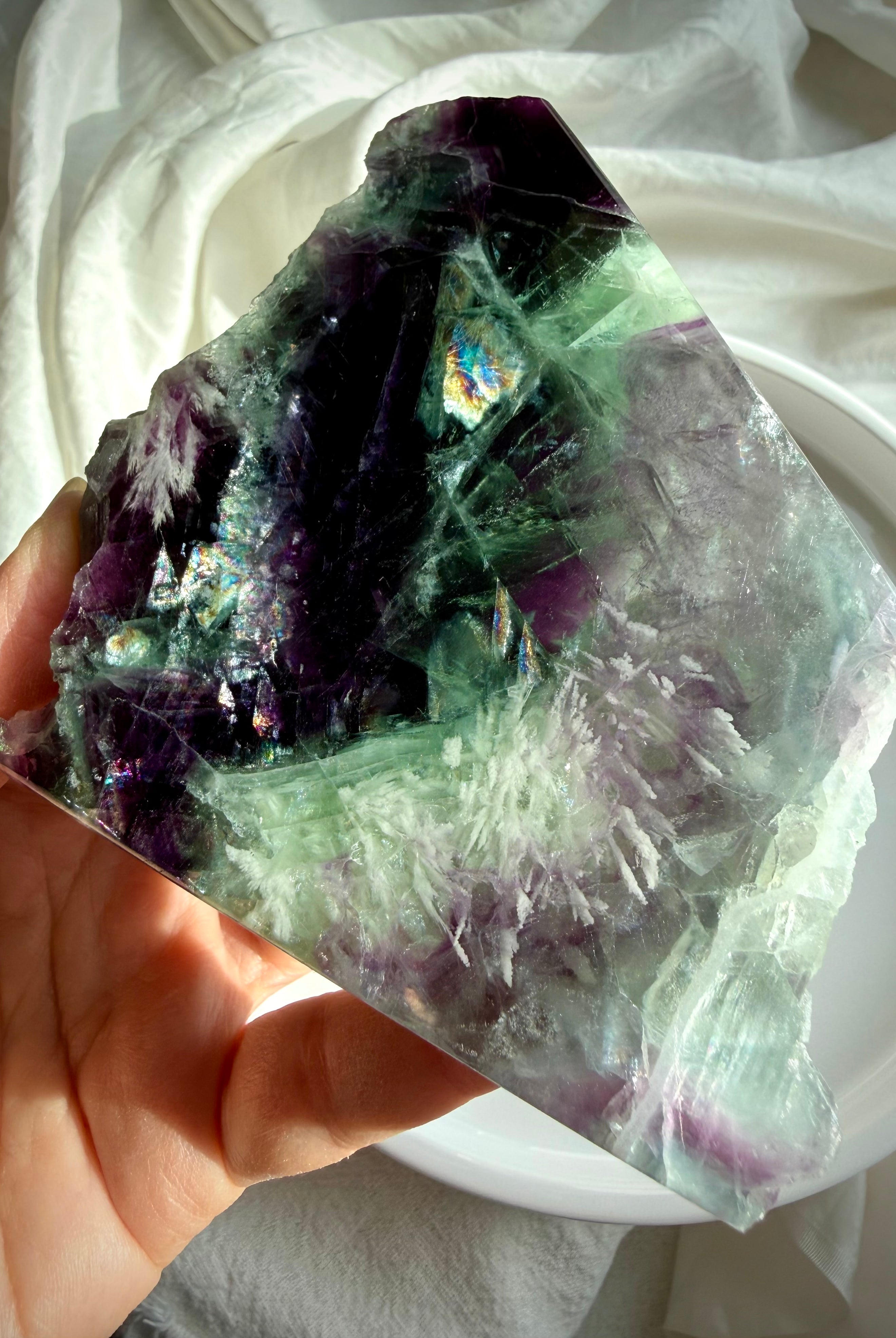 Luminous rainbow fluorite slab with green and violet hues and delicate scolecite snowflakes for peaceful focus and energetic clarity
