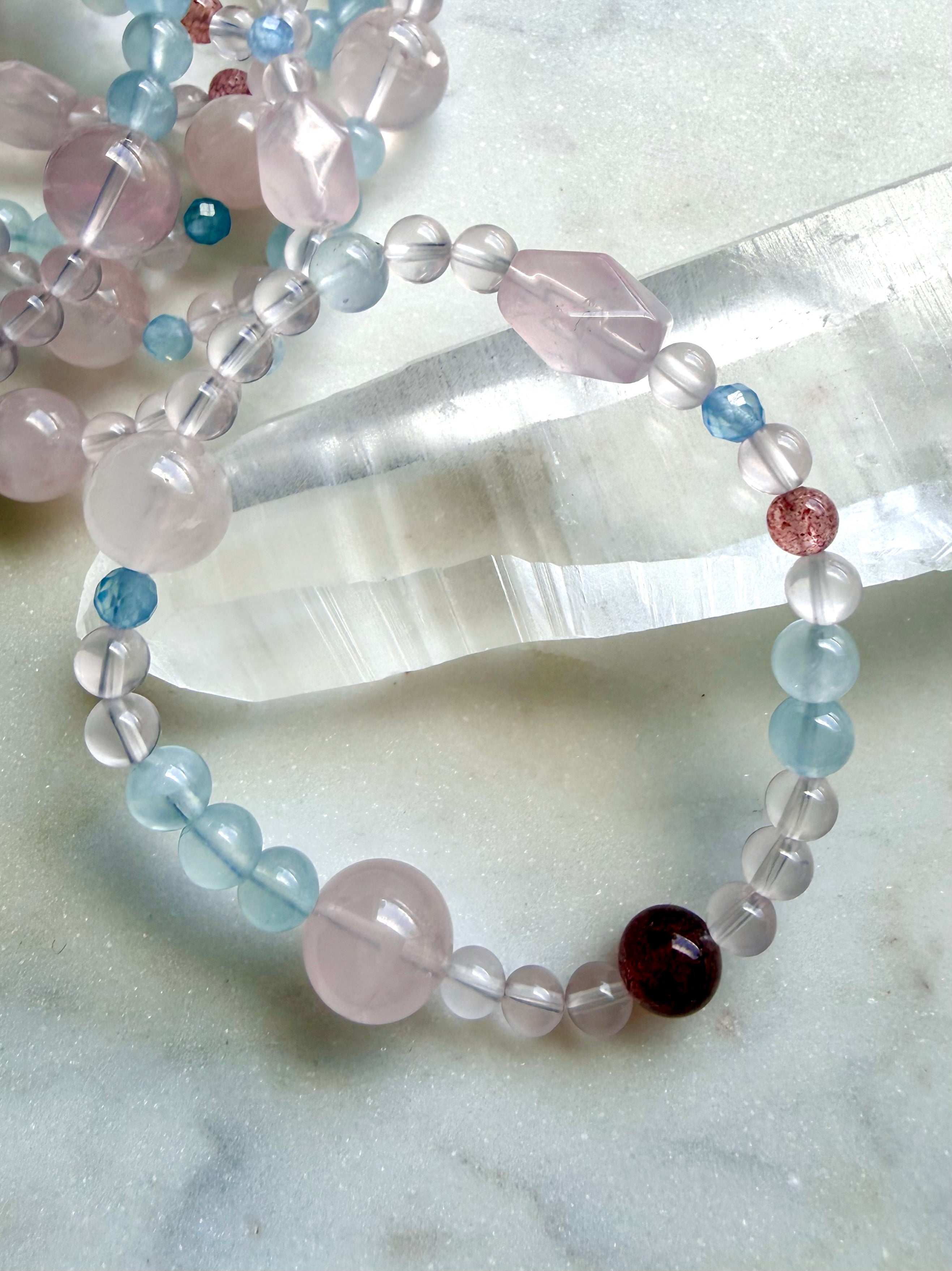 mixed bead crystal bracelet showing variation in bead sizes and shapes, rose quartz aquamarine strawberry quartz bracelet with soft feminine color palette