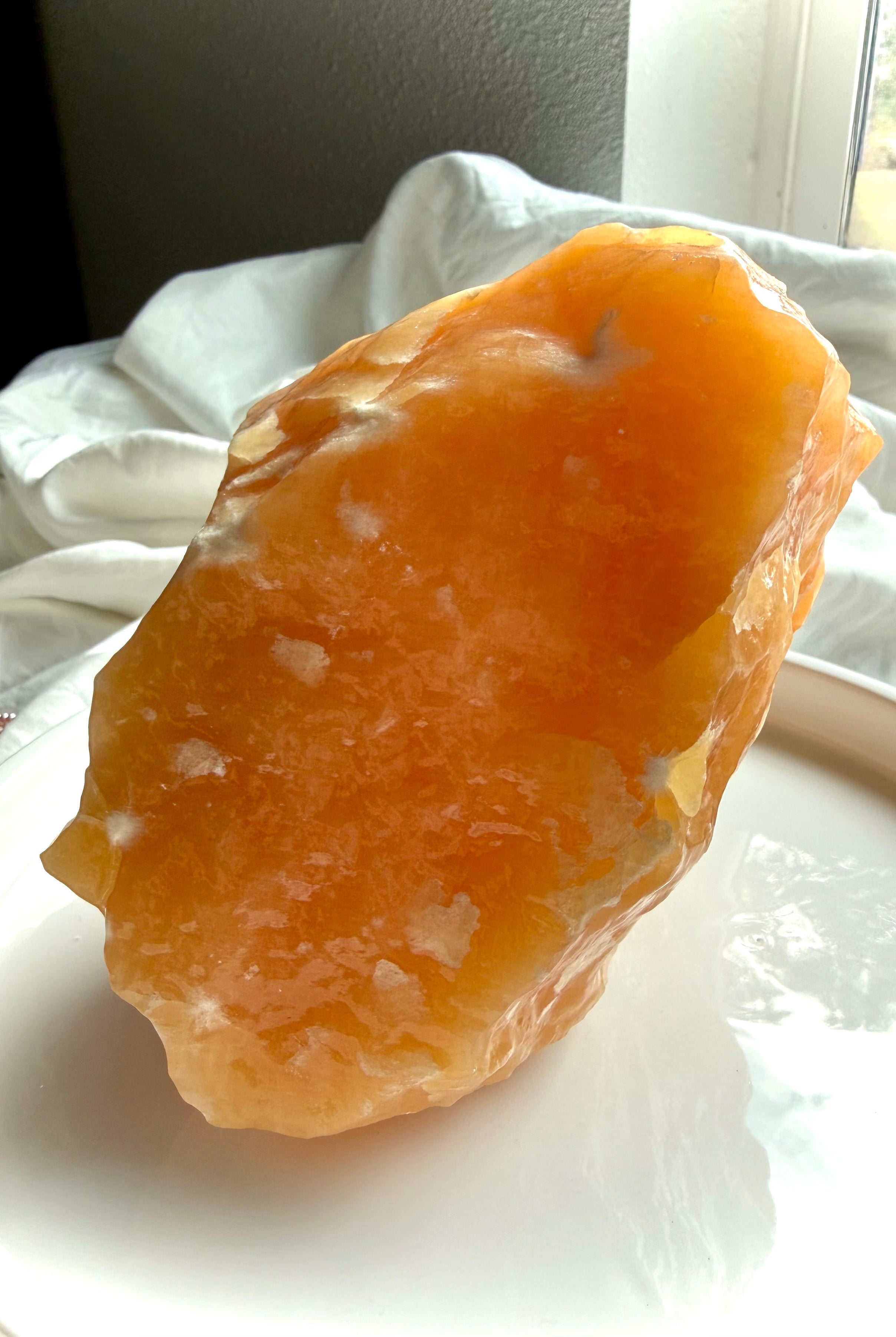 Large Orange Calcite statement crystal from Mexico with glowing translucency, natural formations, and warm uplifting energy for display or meditation