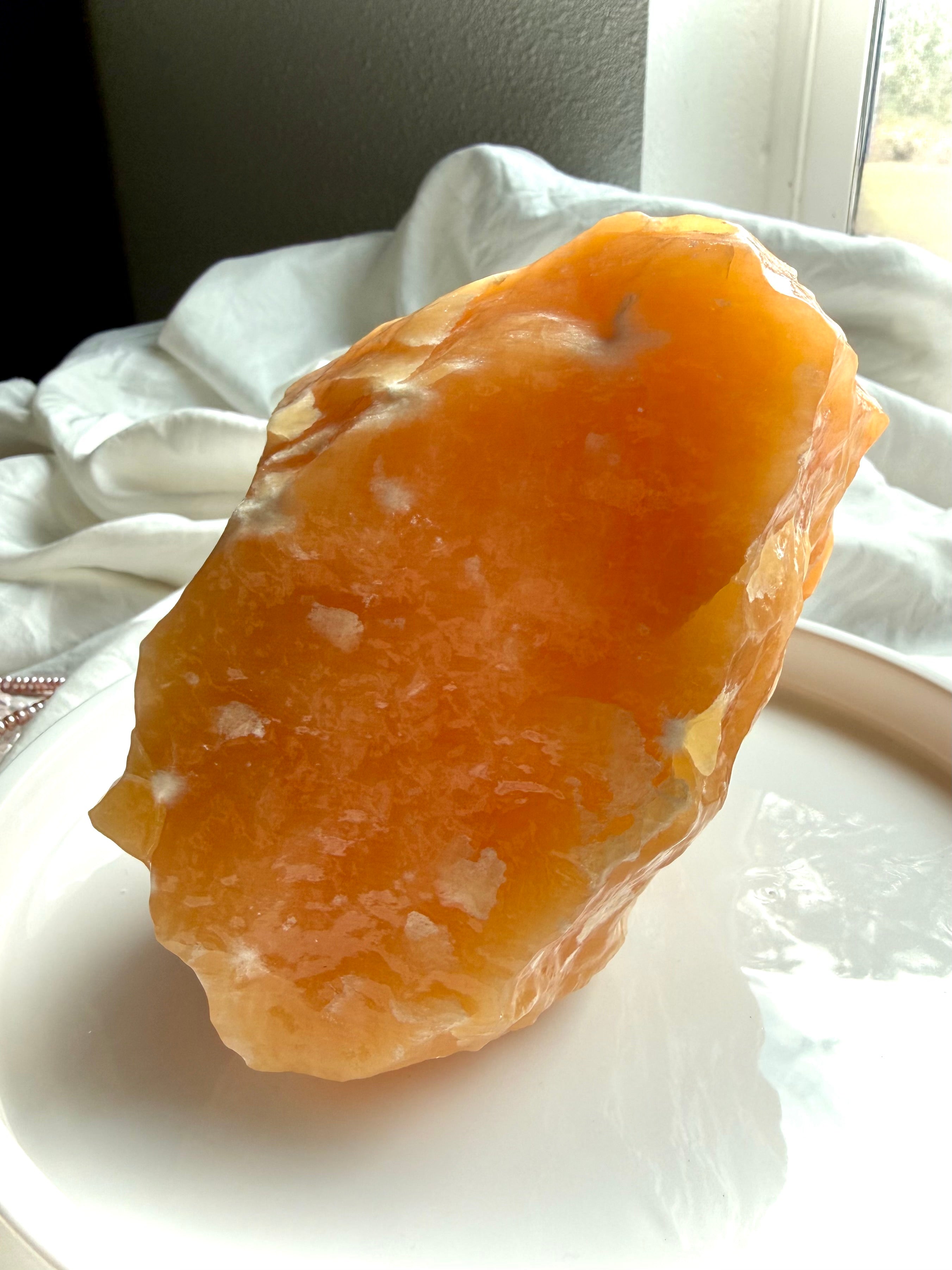 Large Orange Calcite statement crystal from Mexico with glowing translucency, natural formations, and warm uplifting energy for display or meditation