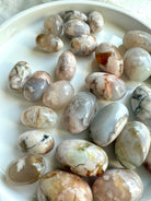 High quality Flower Agate tumbled stones with beautiful pastel colors on a white plate