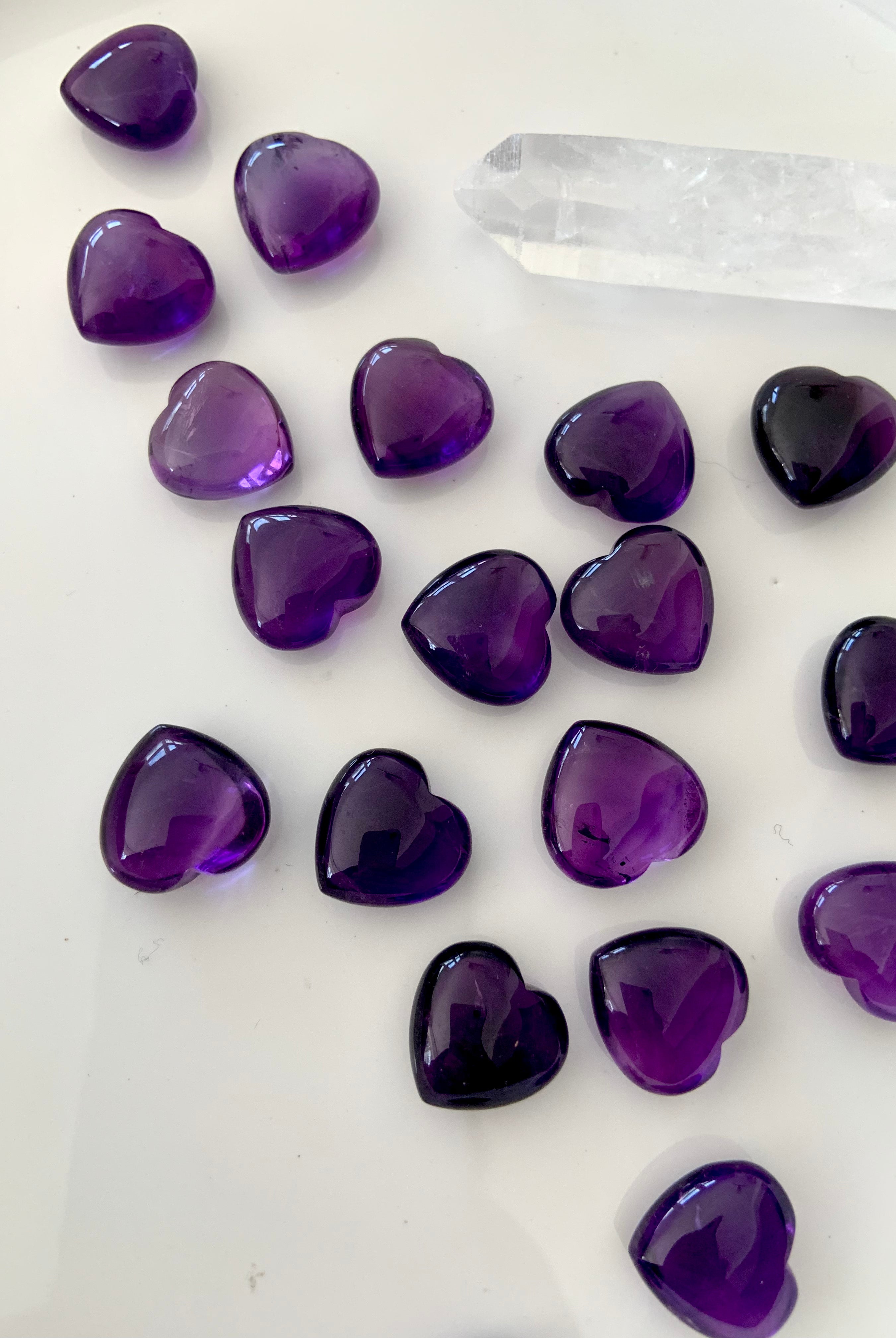 Overhead view of Mini Amethyst hearts with a clear quartz point — heart chakra and crown chakra mini crystals