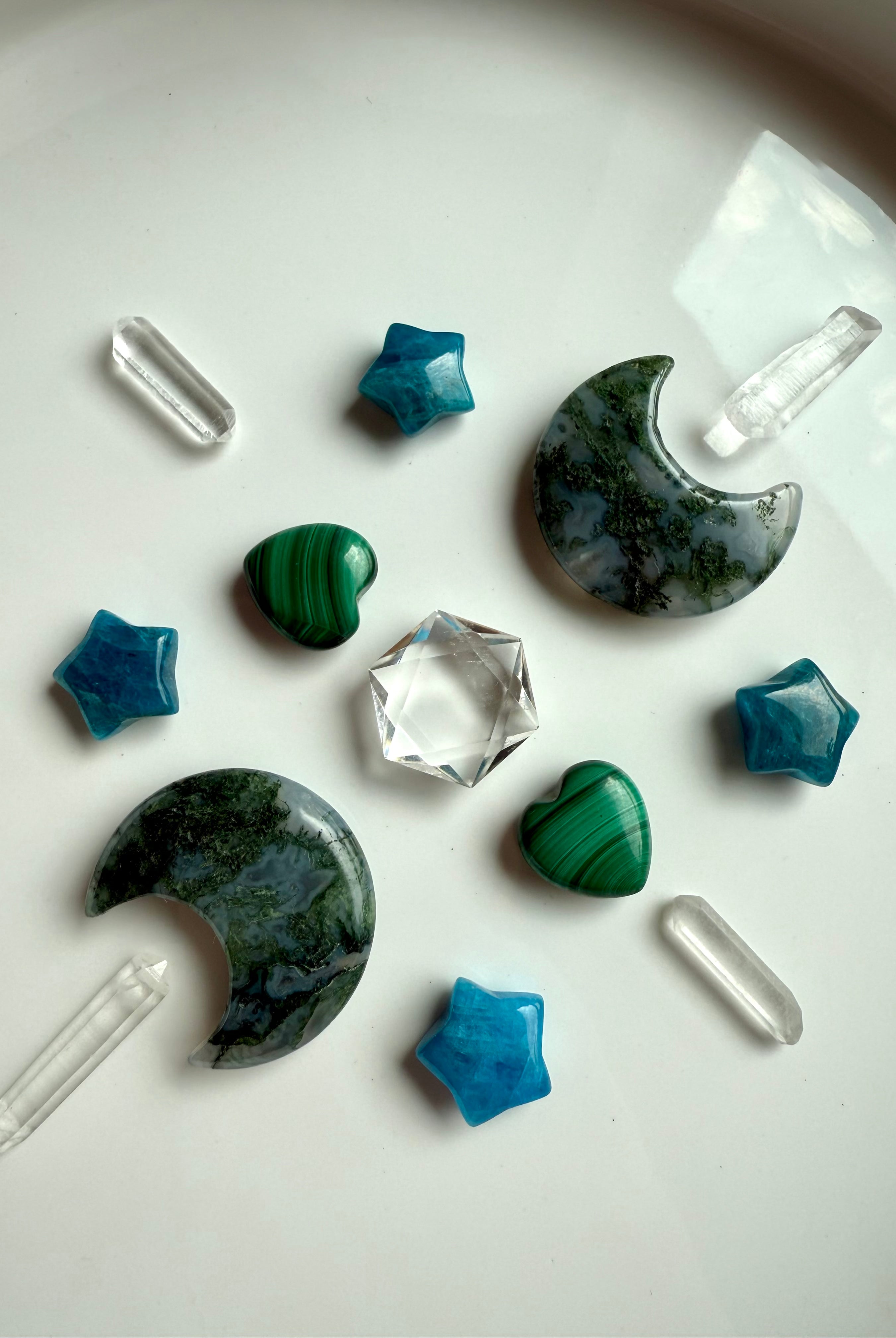 Moss Agate crescent moon carvings in a geometric crystal grid arrangement with mini crystal carvings, quartz points, and a clear quartz hexagon center.