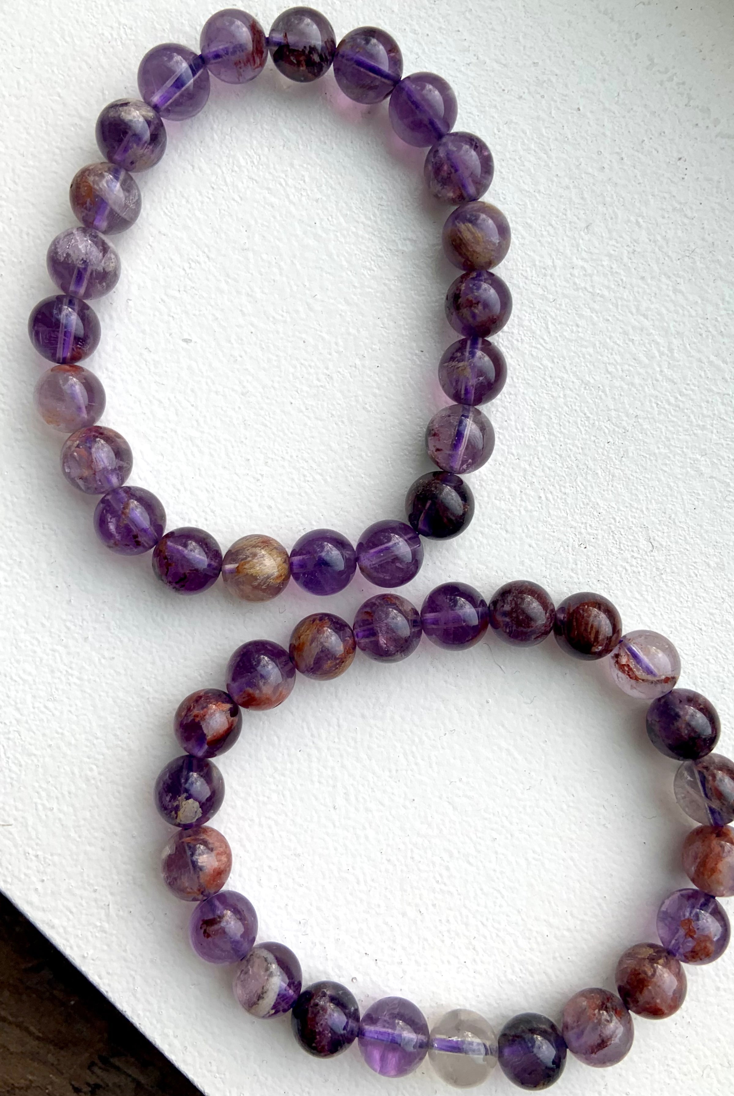 Super 7 Amethyst healing crystal bracelets for spiritual awakening and crown chakra alignment