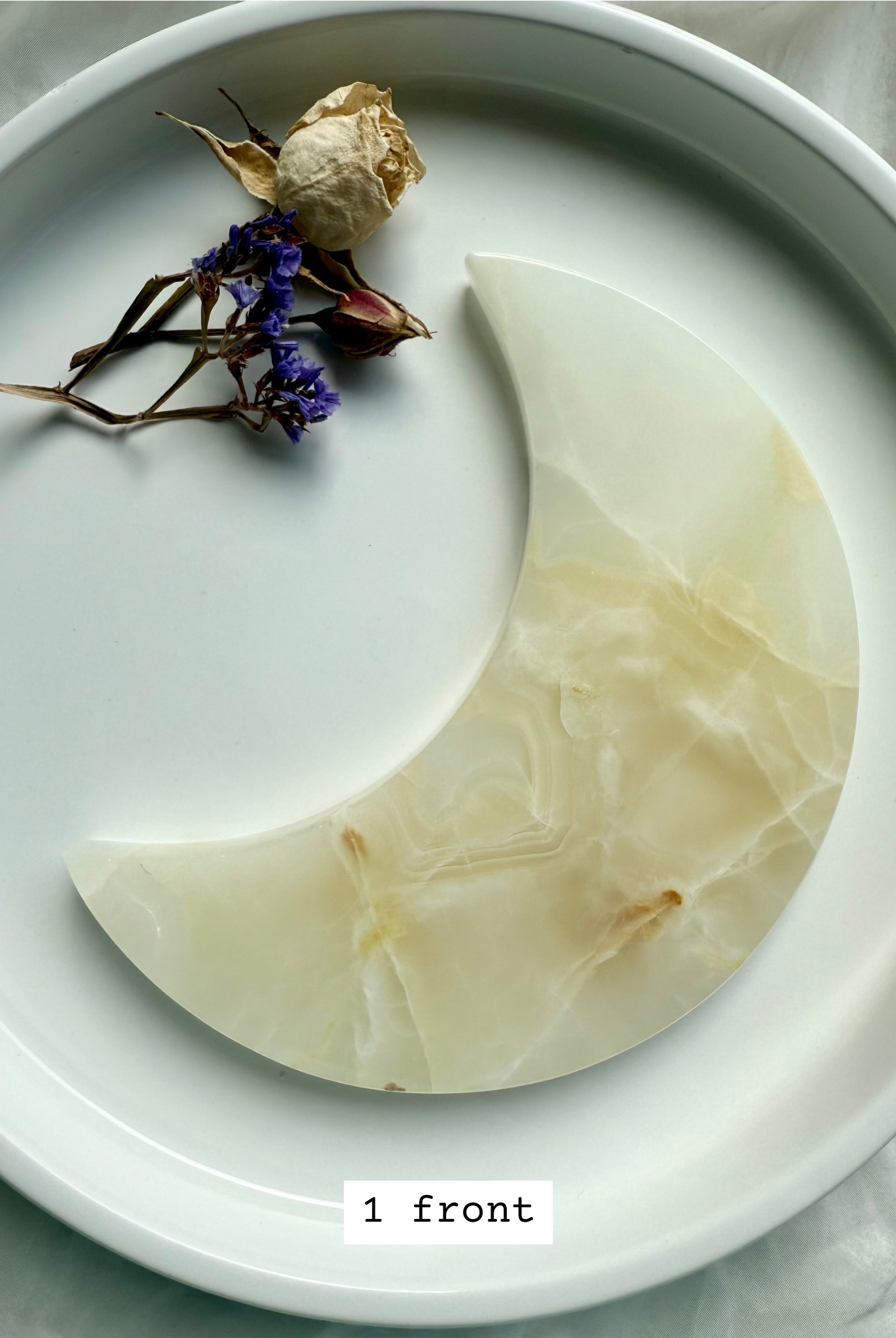 White Onyx Crescent Moon Plate, creamy beige with subtle golden banding, crystal moon carving front view.
