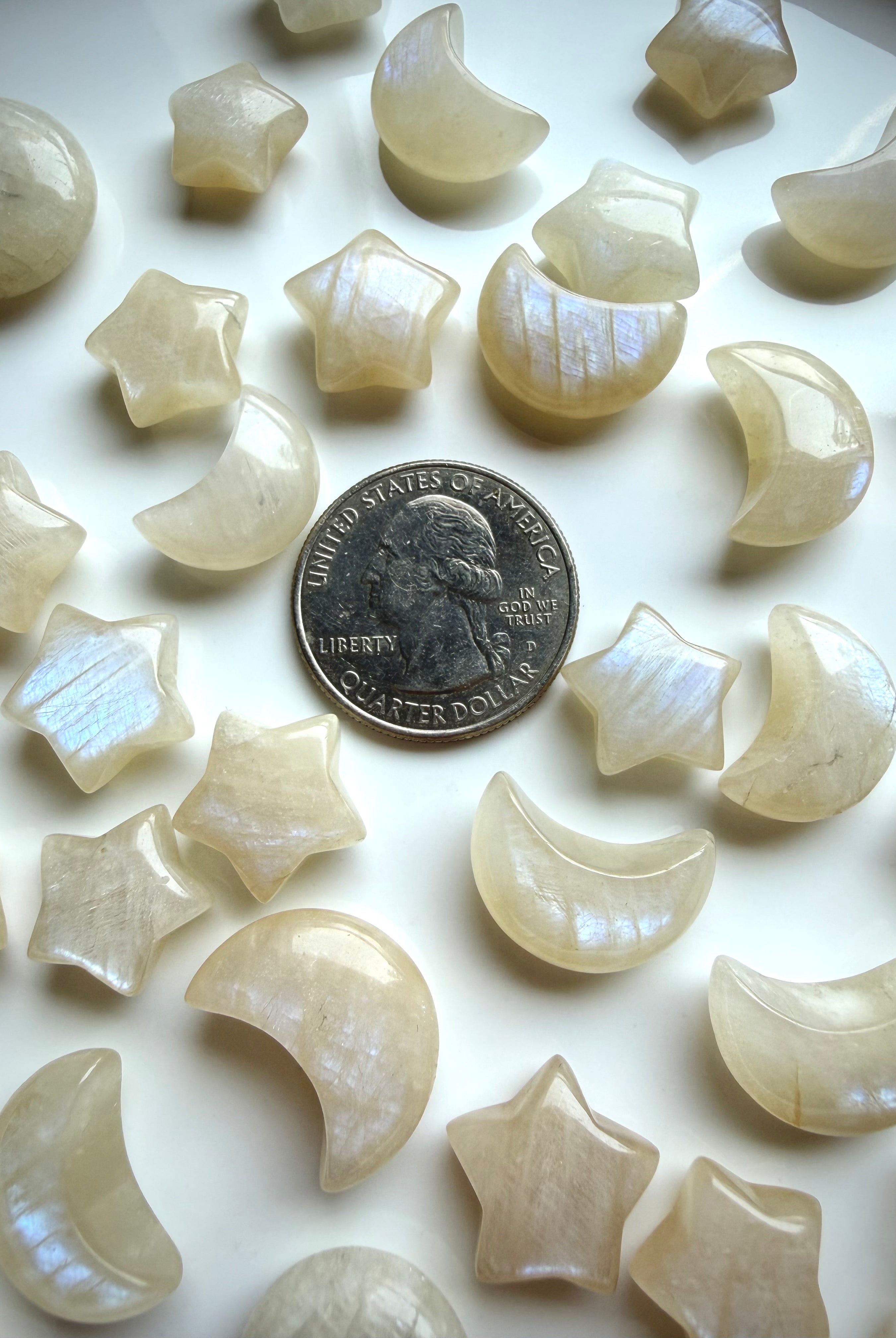 Mini Moonstone crystal carvings with blue flash and quarter for size reference