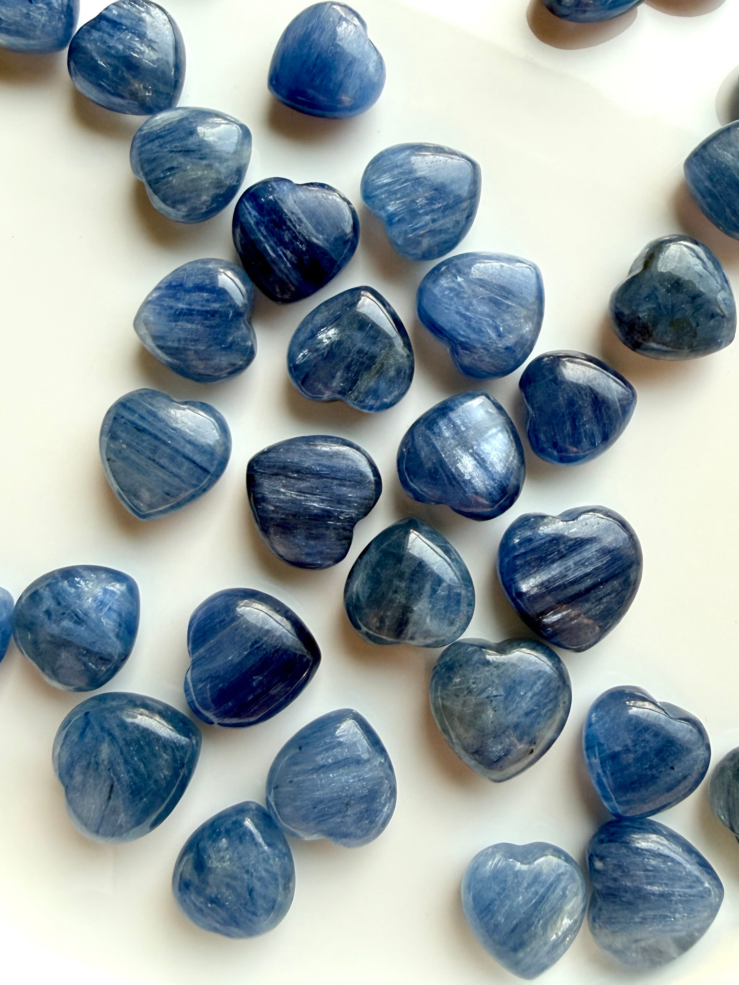 Mini Blue Kyanite heart crystals with silvery blue shimmer and natural quartz inclusions, polished rounded gemstone hearts for throat chakra healing