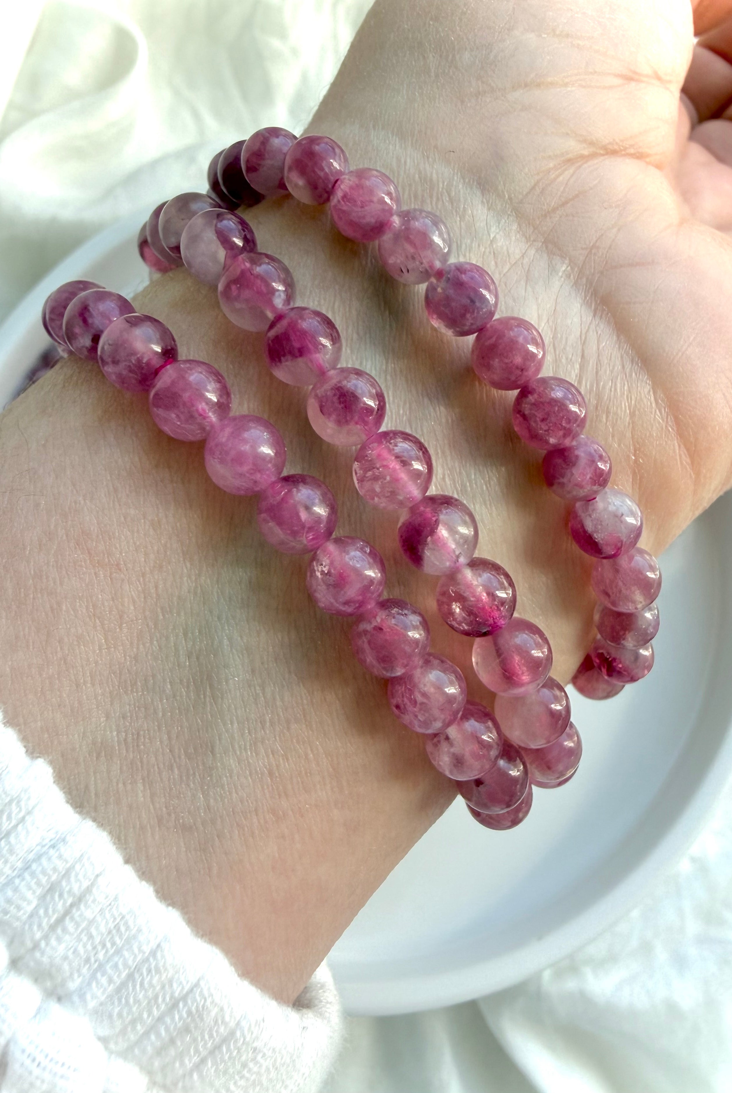 Stack of 3 Pink Tourmaline crystal bracelets featuring translucent pink gemstone beads for October birthstone jewelry and Heart Chakra healing