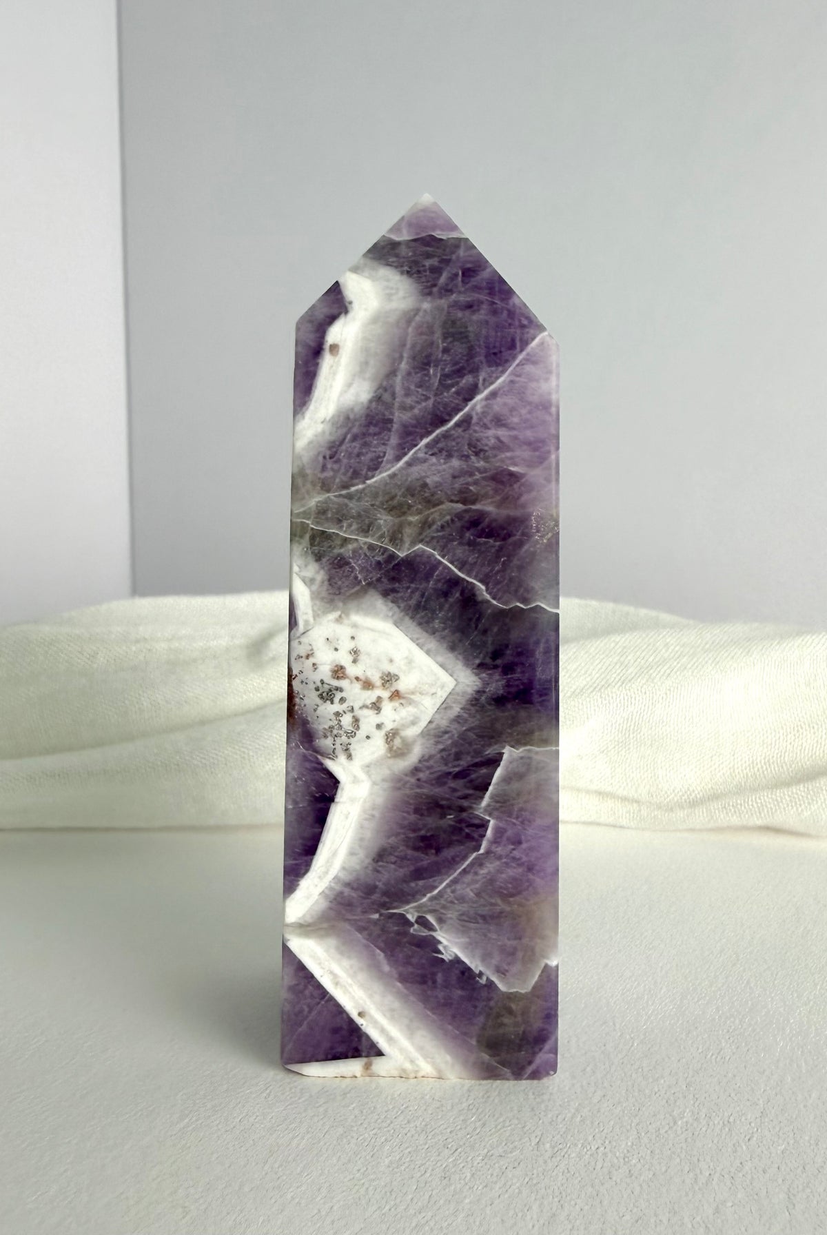 Dream Amethyst crystal point with dramatic purple and white zigzag banding, ideal for meditation, spiritual insight and energy balance
