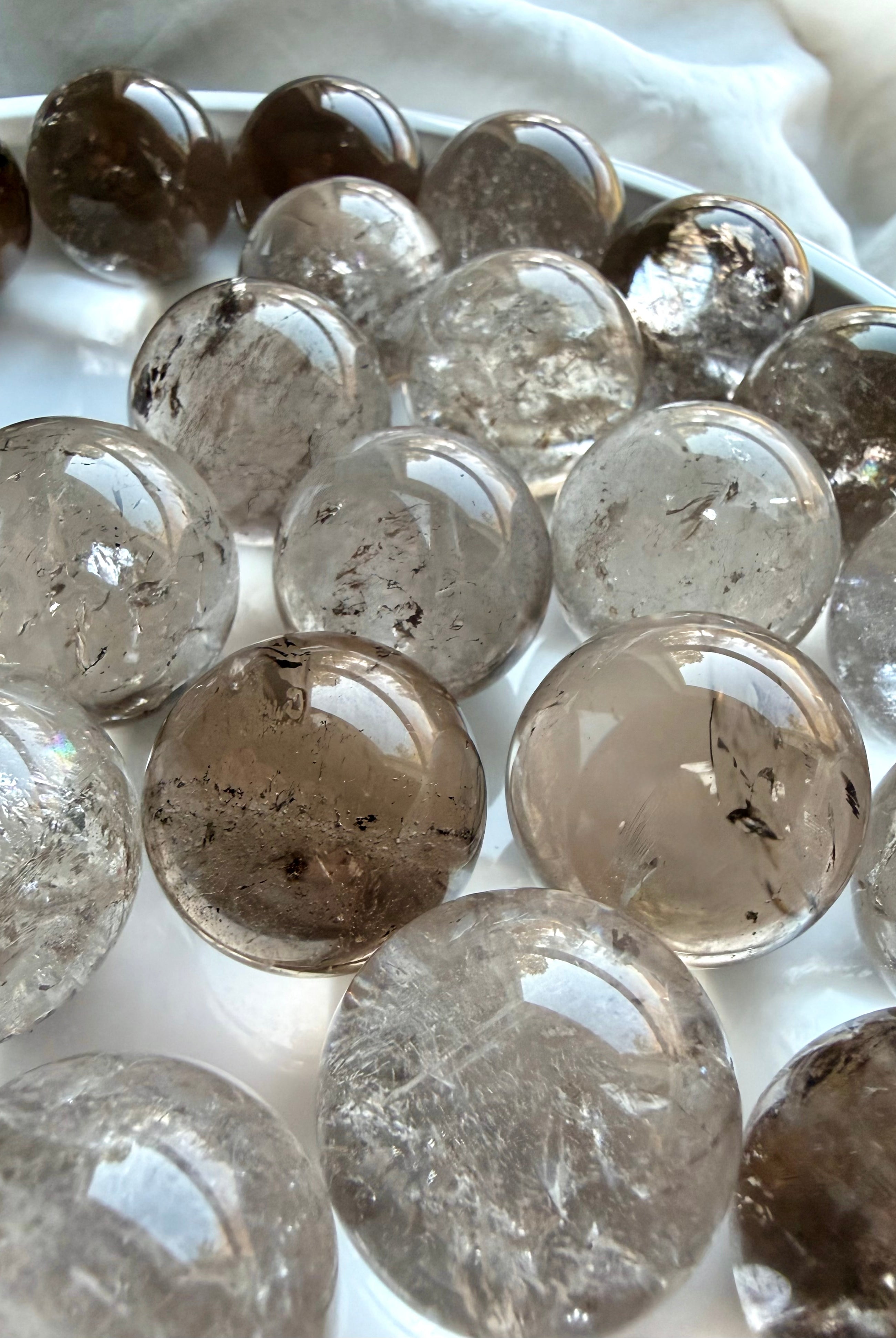 Mini Smoky Quartz spheres displayed in marble bowl with grounding earthy brown and gray tones