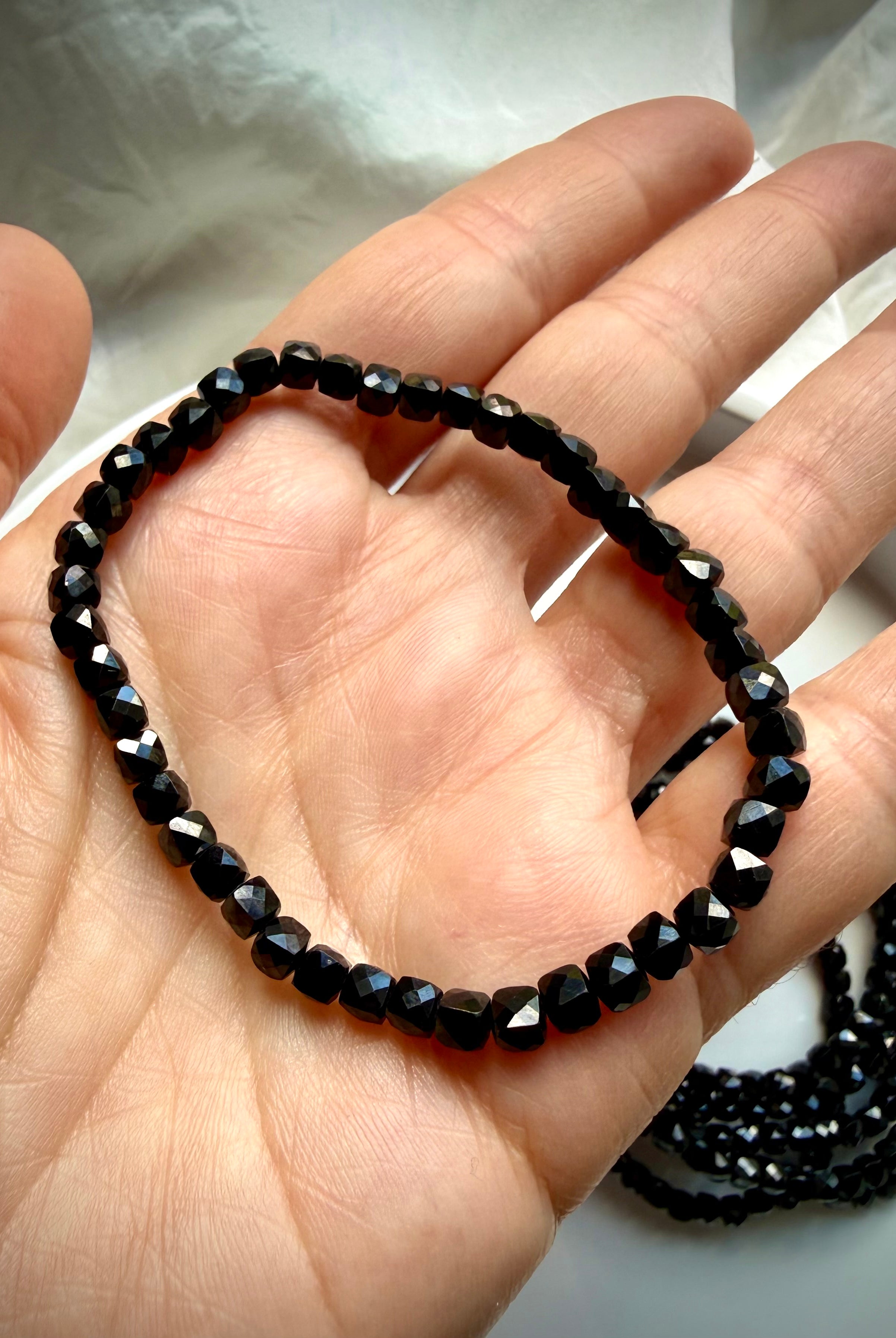black spinel bracelet shown on hand showing bead size and fit for stacking gemstone jewelry