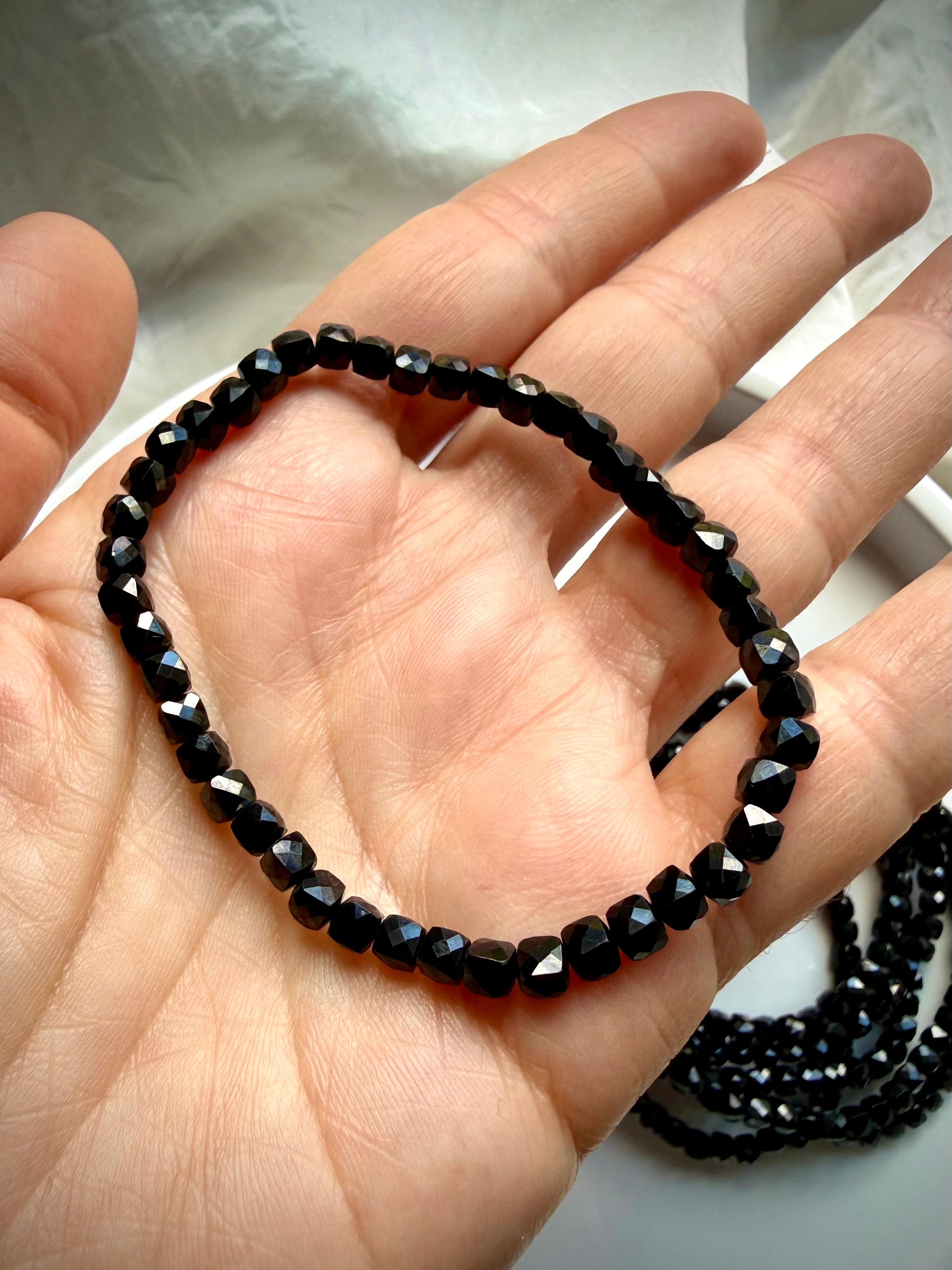 black spinel bracelet shown on hand showing bead size and fit for stacking gemstone jewelry