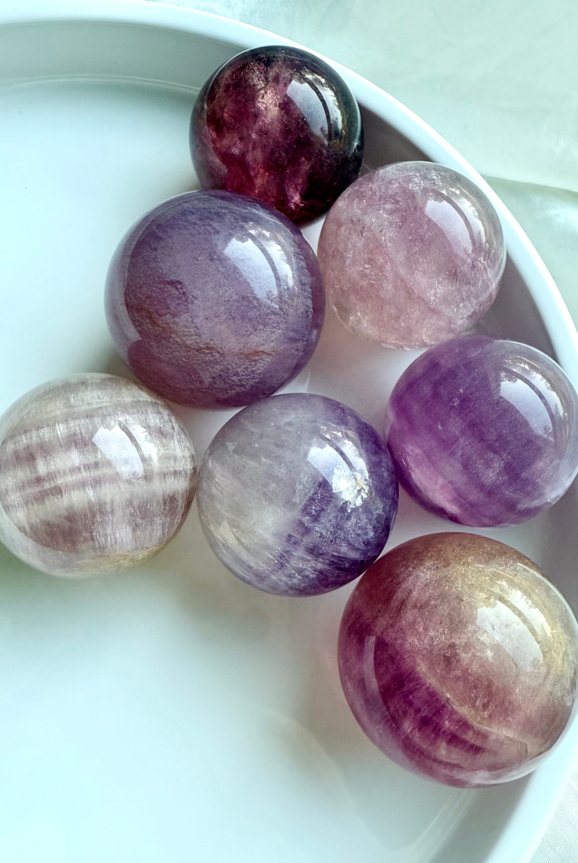 polished Silky Magenta Fluorite spheres with lavender, magenta, and cream banding for third eye chakra energy