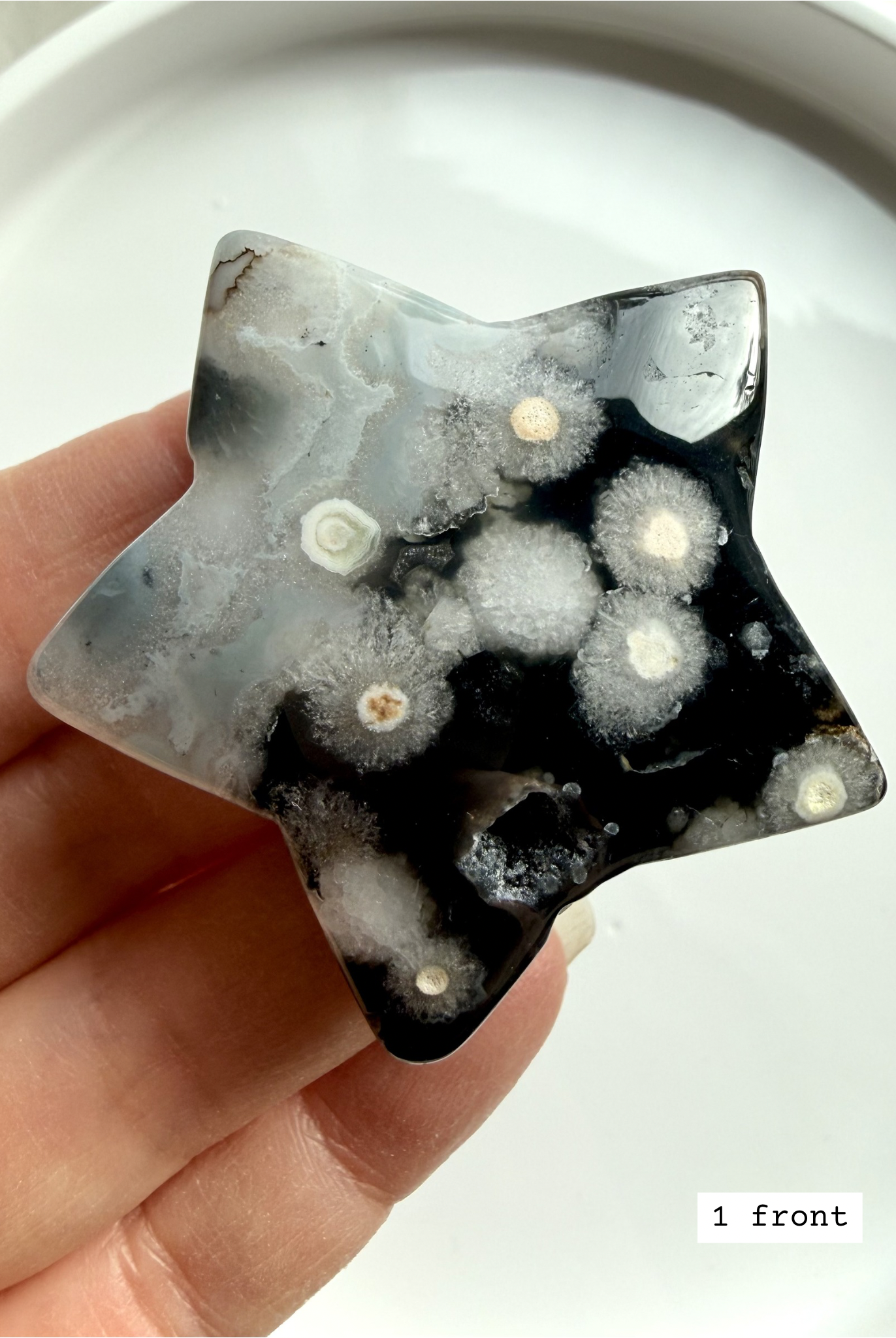 black flower agate star carving #1 front showing white floral plume patterns and polished finish